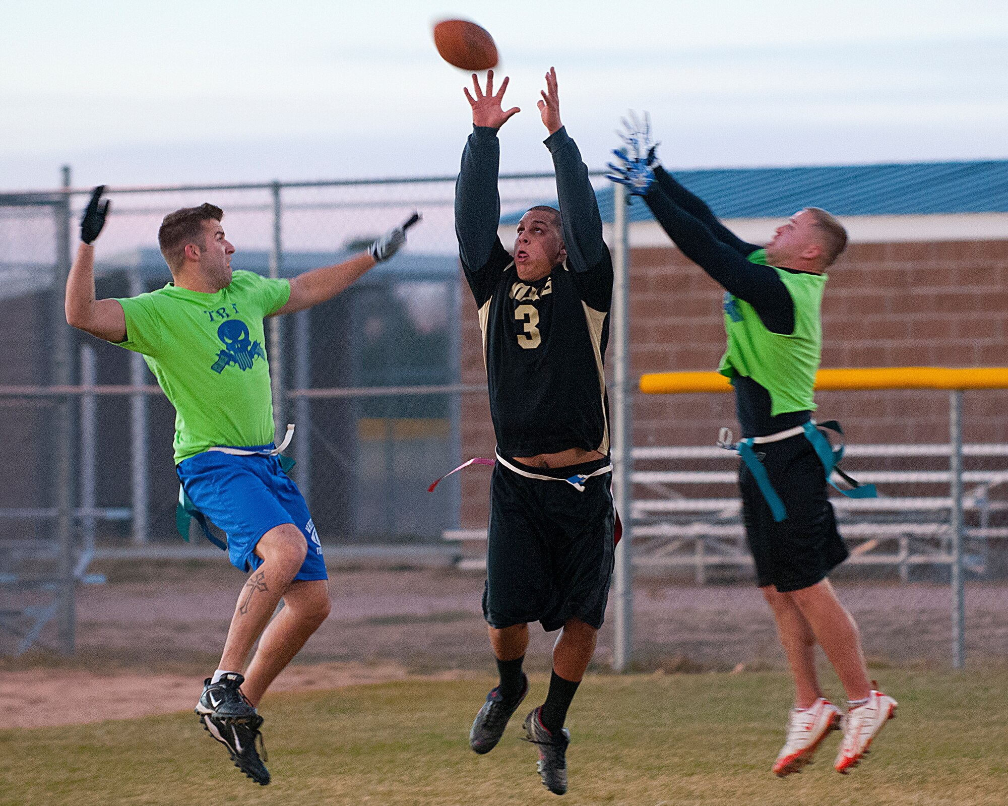 Senior Airman Cliff Coppenbarger and Airman 1st Class Chris Russell, both with the 90th Security Forces Group Tactical Response Force, break up a pass to Senior Airman Anthony Eschete, 90th Maintenance Operations Squadron, during the first of two games in the F. E. Warren flag football championship Nov. 2. The 90th SFG/TRF team went on to win the game 19 to 6 forcing a second game in the double-elimination tournament, which they won 19 to 13. (U.S. Air Force photo by R.J. Oriez)