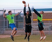 Senior Airman Cliff Coppenbarger and Airman 1st Class Chris Russell, both with the 90th Security Forces Group Tactical Response Force, break up a pass to Senior Airman Anthony Eschete, 90th Maintenance Operations Squadron, during the first of two games in the F. E. Warren flag football championship Nov. 2. The 90th SFG/TRF team went on to win the game 19 to 6 forcing a second game in the double-elimination tournament, which they won 19 to 13. (U.S. Air Force photo by R.J. Oriez)