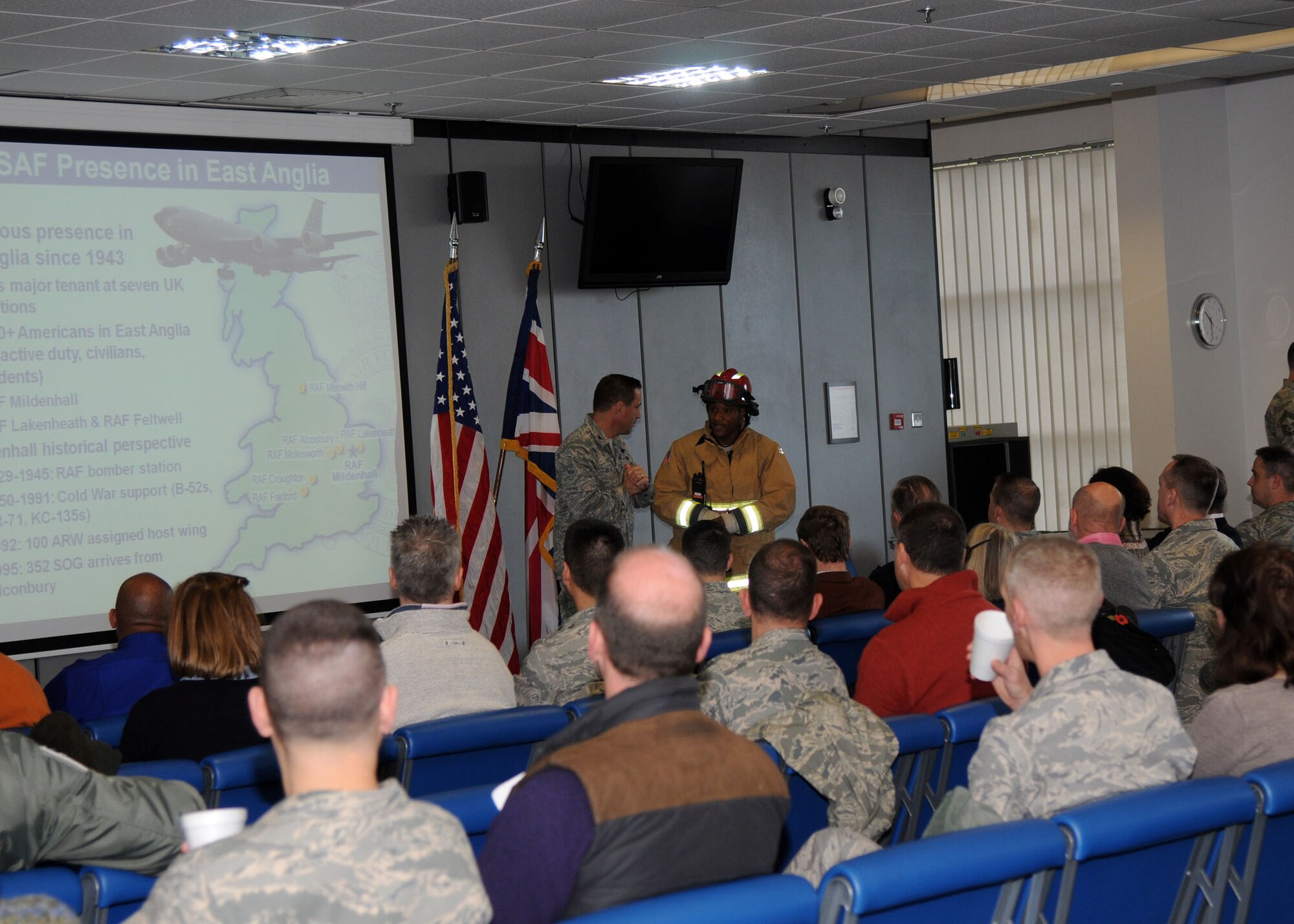 Master Sgt. Corey Coleman, 100th Civil Engineer Squadron assistant fire chief, starts a fire evacuation exercise during a briefing on the 100th Air Refueling Wing’s mission given by Col. Christopher Kulas, 100th Air Refueling Wing commander, during Honorary Commanders’ Day Nov. 8, 2012, at RAF Mildenhall, England. Also, during Honorary Commanders’ Day, there were job demonstrations and briefings that showcased several squadrons on base, allowing honorary commanders to learn more about the mission, vision and priorities of RAF Mildenhall. (U.S. Air Force photo by Airman 1st Class Kelsey Waters/Released)