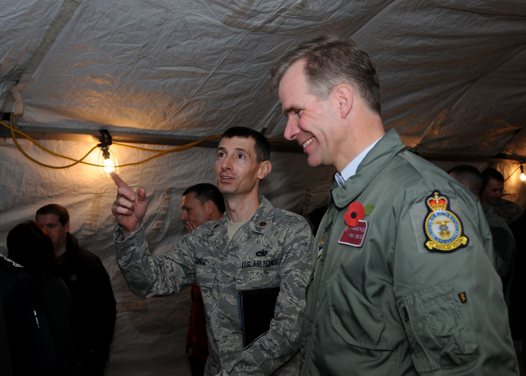 Maj. Timothy Voruz, 100th Logistics Readiness Squadron commander, speaks with Hamish Ross, 100th LRS honorary commander, during the Honorary Commanders’ Day Nov. 8, 2012, at RAF Mildenhall, England. During Honorary Commanders’ Day, there were job demonstrations and briefings that showcased several squadrons on base, allowing honorary commanders to learn more about the mission, vision and priorities of RAF Mildenhall. (U.S. Air Force photo by Airman 1st Class Kelsey Waters/Released)