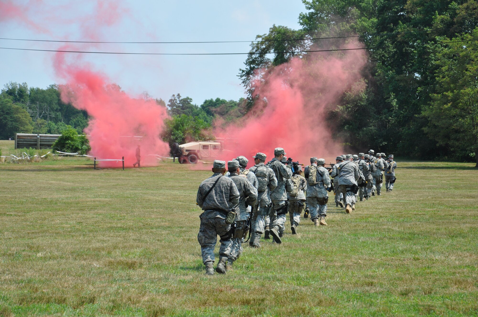 Students attending Combat Airmen Skills Training at Joint Base McGuire-Dix-Lakehurst, N.J. move in tactical line formations while using smoke to cover their actions during the tactical movement block at CAST recently. The U.S. Air Force Expeditionary Center’s courses, including CAST and 11 others, continued despite power outages lasting a week and no phone connectivity due to damages from Hurricane Sandy. Nearly 200 students graduated from EC courses this week.  (U.S. Air Force photo by Capt. Sybil Taunton/Released.)