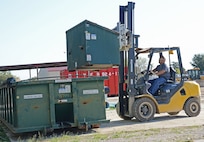 Jose Carlos Mireles, contract recycle technician, uses a forklift to unload a recycle receptacle Nov. 5 at Joint Base San Antonio-Randolph.  (U.S. Air Force photo by Benjamin Faske)