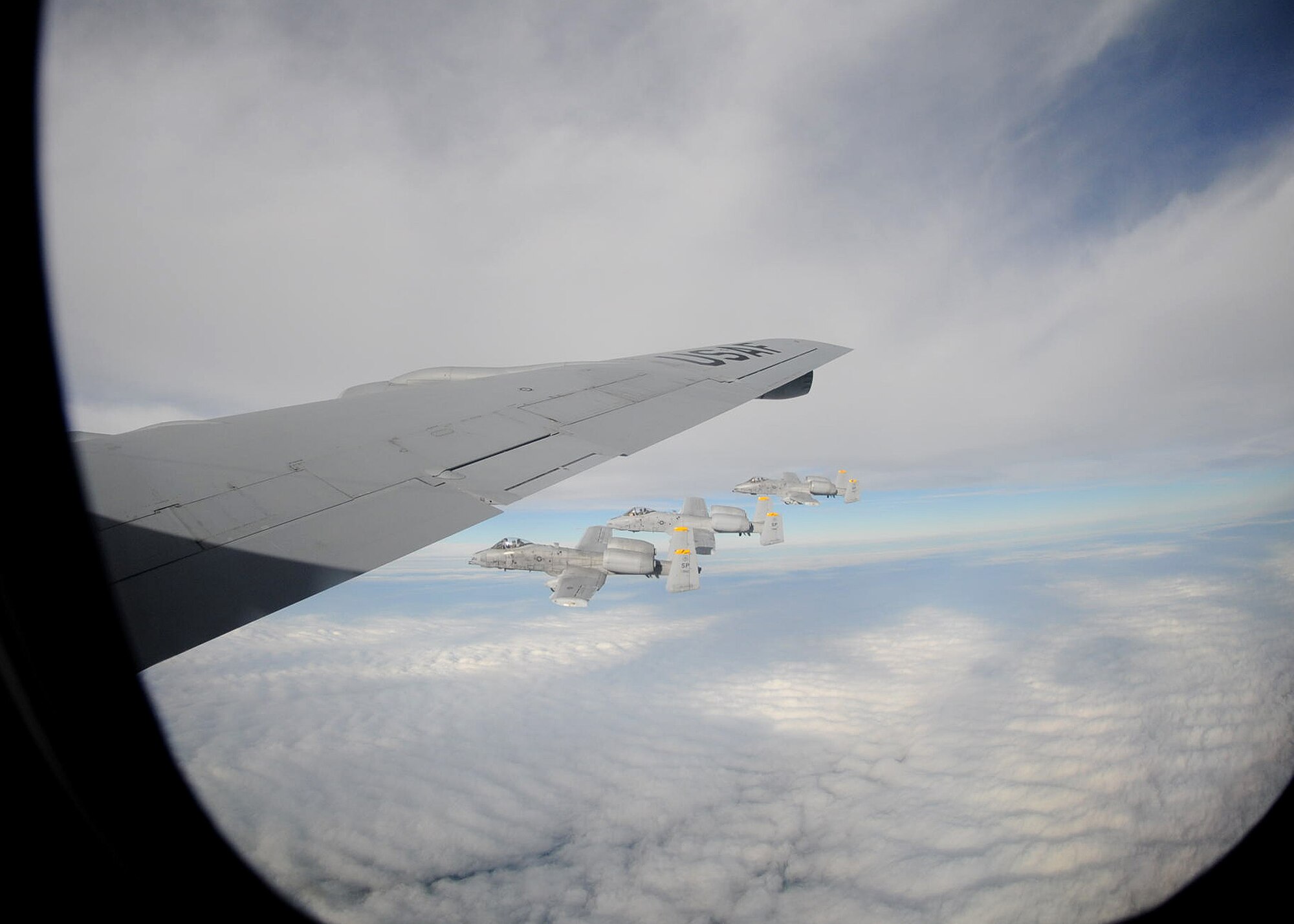 Three A-10 Thunderbolt IIs from Spangdahlem Air Base, Germany, fly beside a KC-135 Stratotanker from the 100th Air Refueling Wing, RAF Mildenhall, England, after receiving fuel Nov. 8, 2012, over Germany.  The A-10s received a total of 6,000 pounds of fuel before continuing their training mission. (U. S. Air Force photo by Tech. Sgt. Latisha Cole/Released)
