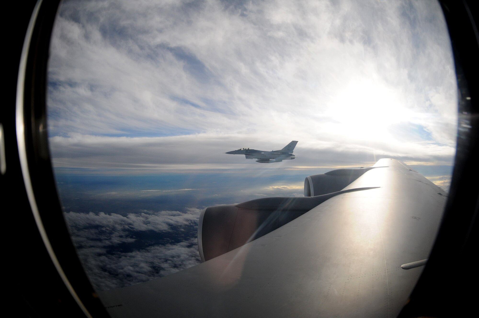 An F-16 Fighting Falcon from Spangdahlem Air Base, Germany, flies alongside a KC-135 Stratotanker from the 100th Air Refueling Wing, RAF Mildenhall, England, after receiving fuel Nov. 8, 2012, over Germany.  Each F-16 received 5,000 pounds of fuel before continuing its training mission.   (U. S. Air Force photo by Tech. Sgt. Latisha Cole/Released)