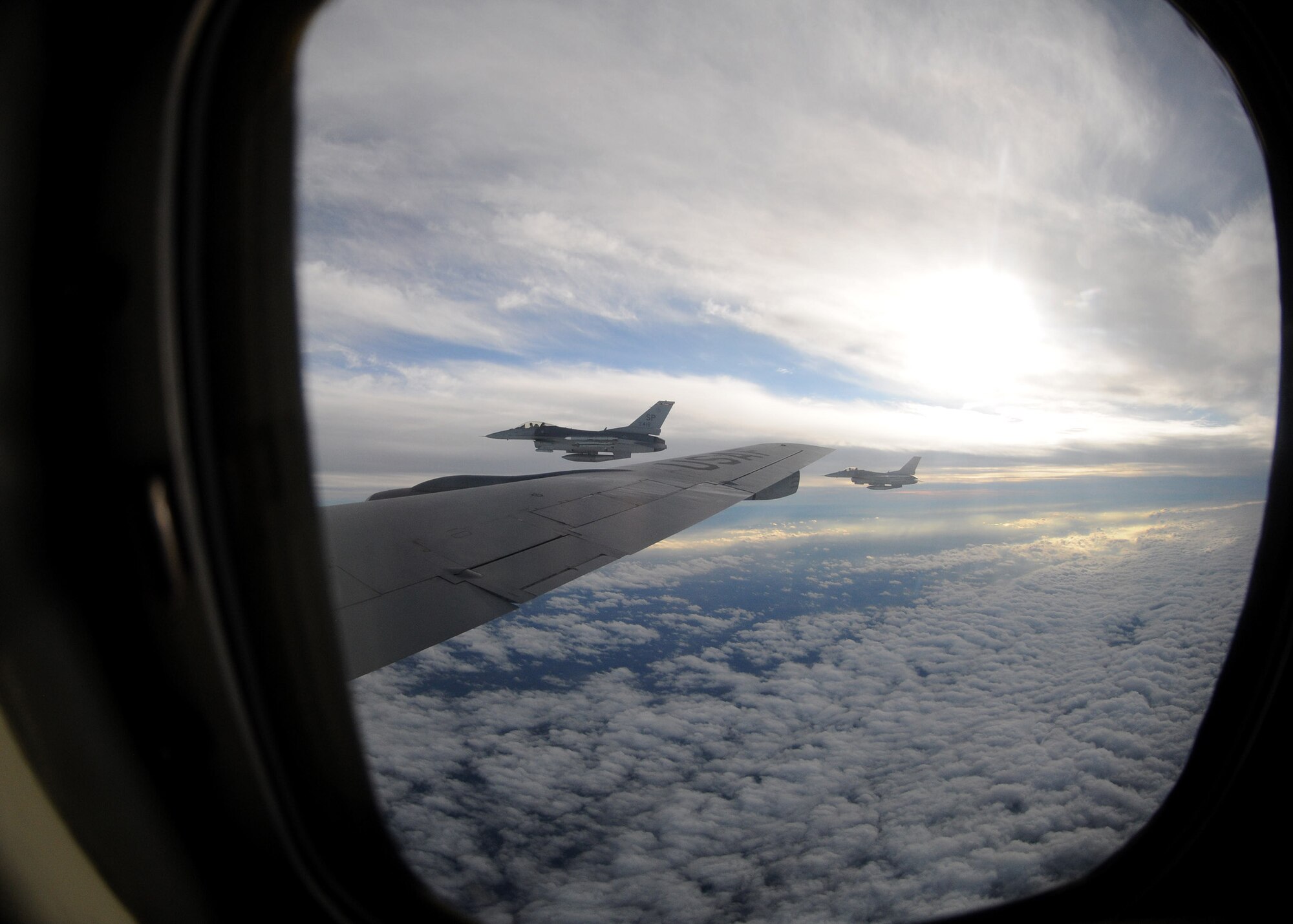Two F-16 Fighting Falcons from Spangdahlem Air Base, Germany, fly alongside a KC-135 Stratotanker from the 100th Air Refueling Wing, RAF Mildenhall, England, after receiving fuel Nov. 8, 2012, over Germany.  Each F-16 received 5,000 pounds of fuel before continuing on its training mission.  (U. S. Air Force photo by Tech. Sgt. Latisha Cole/Released)