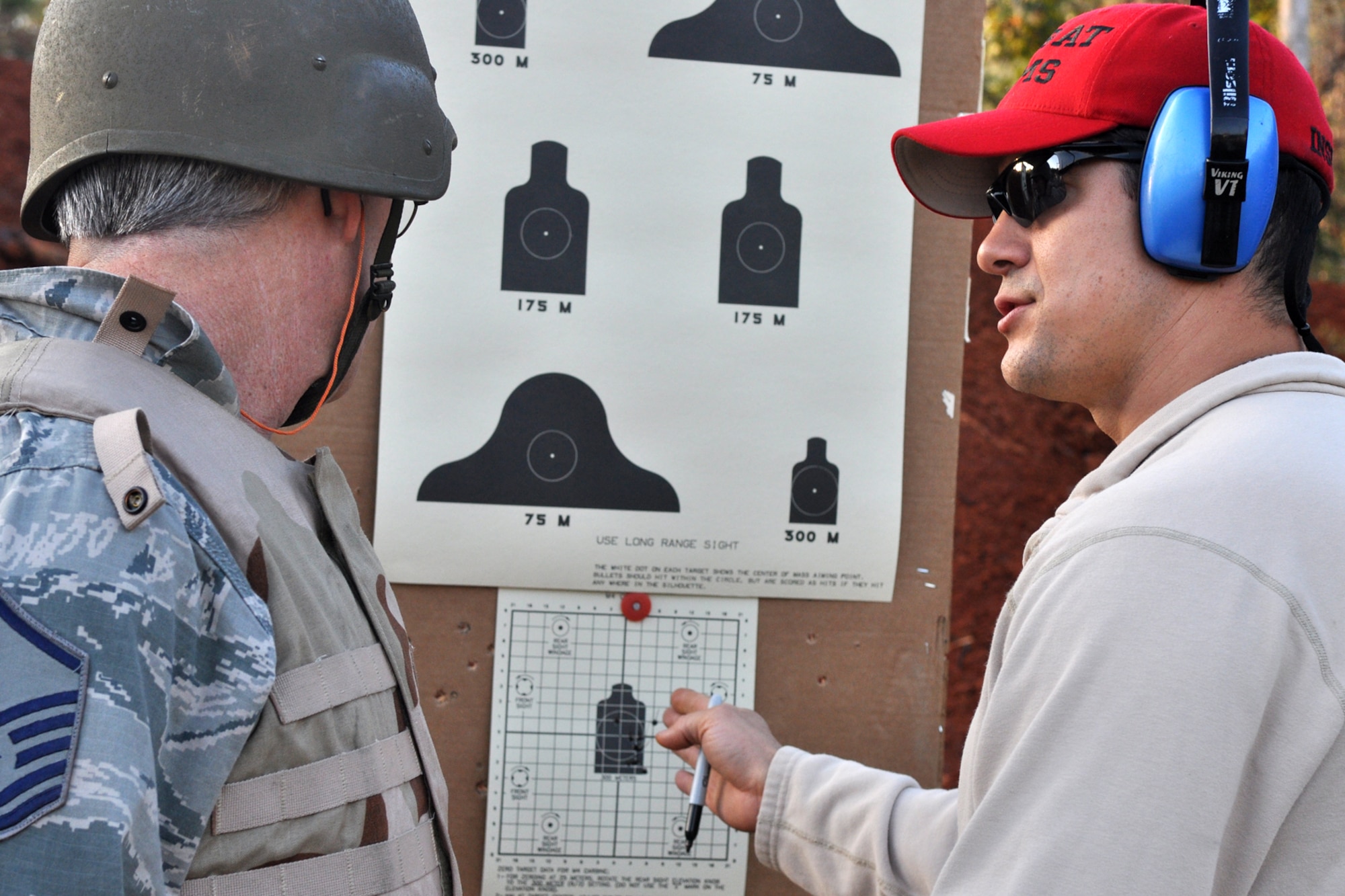 Staff Sgt. Josh Feliciano, who is a Combat Arms instructor assigned to the 307th Security Forces Squadron, tells Master Sgt. David Williford what a good grouping he has at a firing range near Barksdale Air Force Base, La., Nov. 3, 2012. Williford is a firefighter assigned to the 307th Civil Engineer Squadron. (U.S. Air Force photo by Master Sgt. Jeff Walston/Released) 