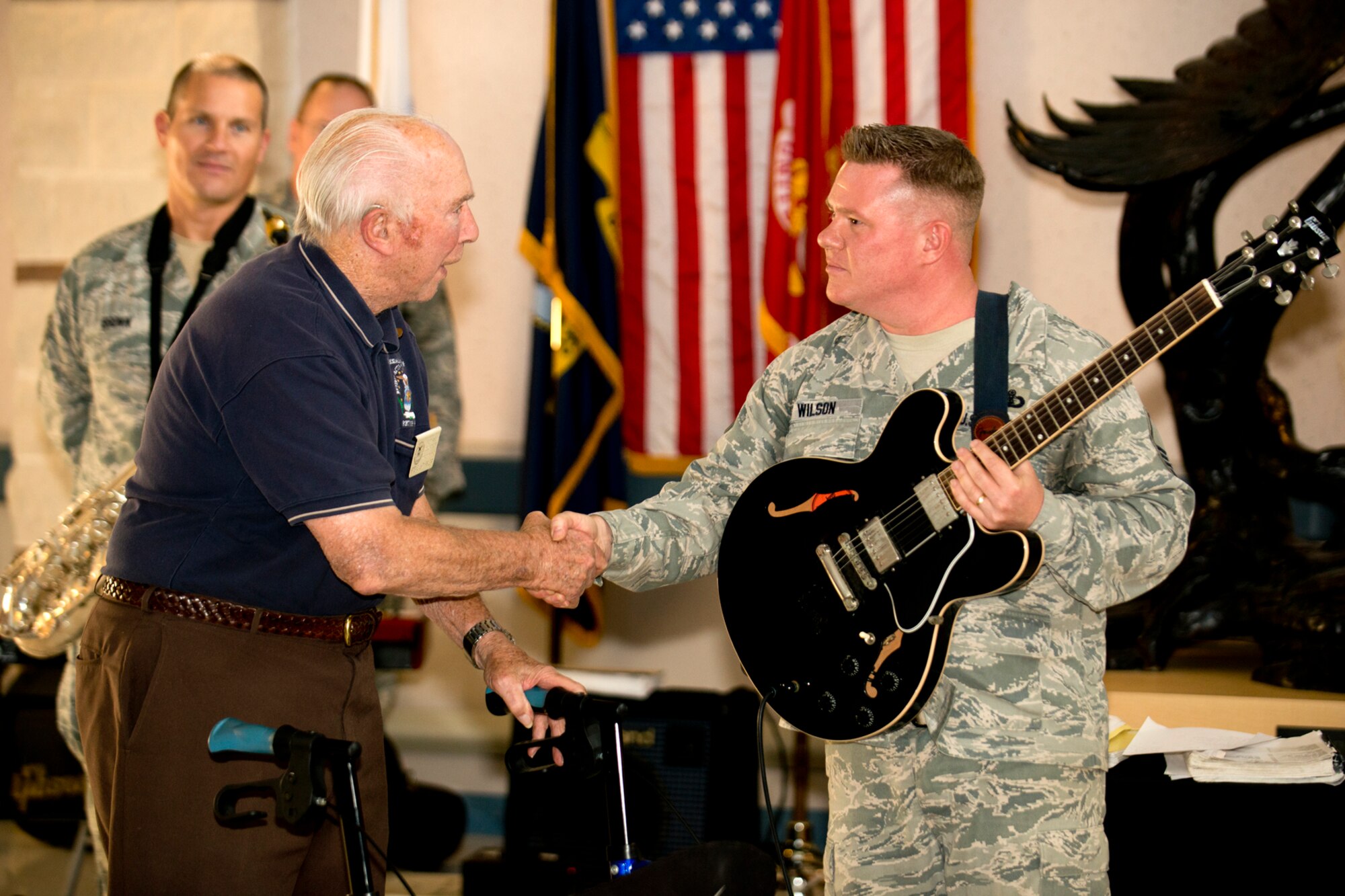 Retired U.S. Air Force Col. Steve dePyssler thanks Master Sgt. Steve Wilson for performing at the Northwest Louisiana Veterans Home, Nov. 6, 2012, Bossier City, La. Wilson and his ensemble are members of the U.S. Air Force Band of the West and are in town to support the Global Strike Challenge score posting ceremony. (U.S. Air Force photo by Master Sgt. Greg Steele/Released)