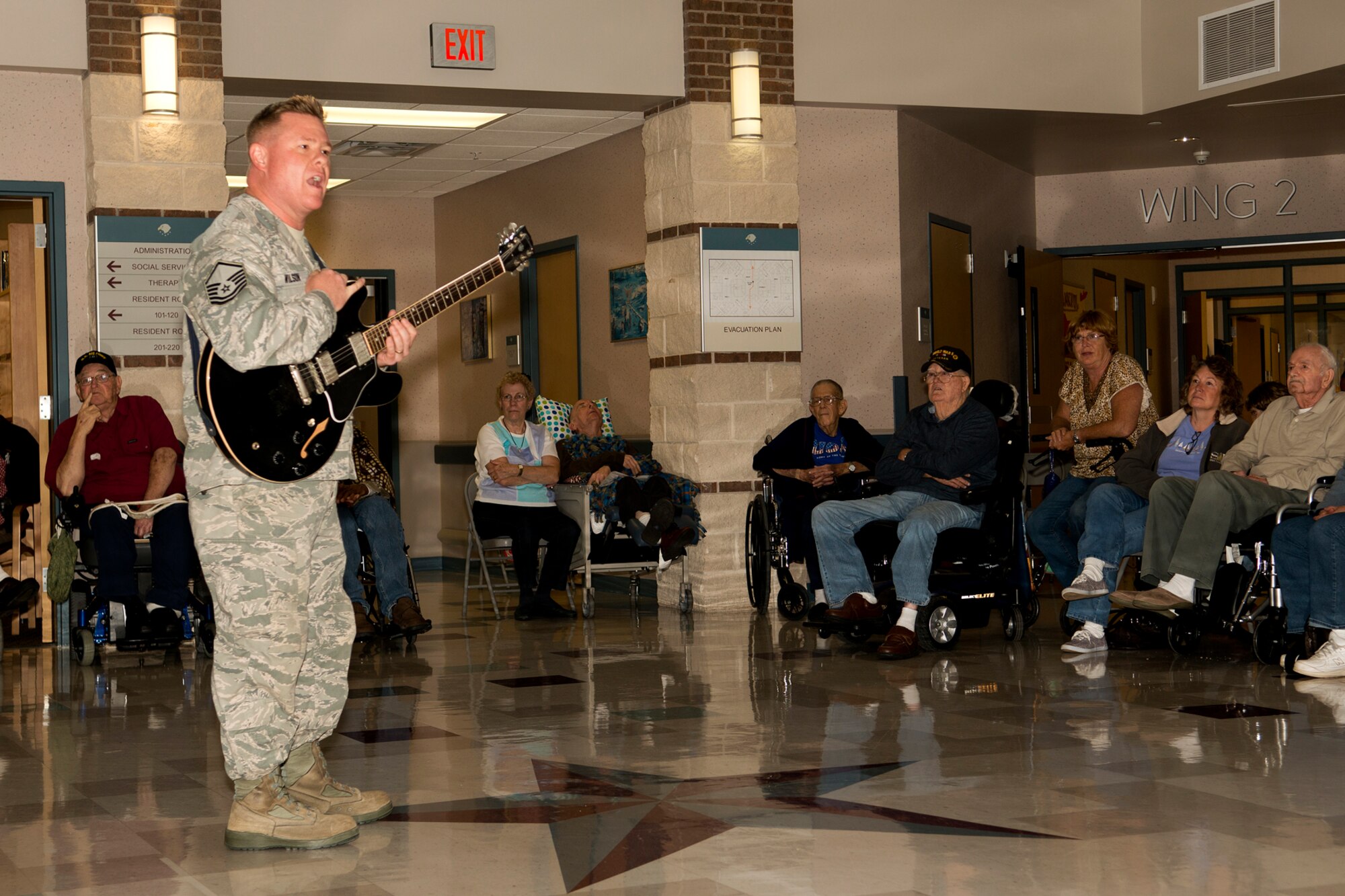U.S. Air Force Master Sgt. Steve Wilson talks to a group of veterans at the Northwest Louisiana Veterans Home, Nov. 6, 2012, Bossier City, La. Wilson is a member of the U.S. Air Force Band of the West and his ensemble  visited the veterans home, performing songs from the 20s, 30s and 40s. (U.S. Air Force photo by Master Sgt. Greg Steele/Released)