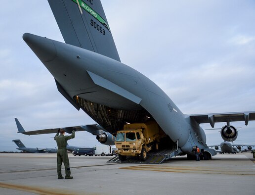 Airman 1st Class Patrick Russ marshals a truck out of a C-17 Globemaster III aircraft Nov. 5, 2012, in support of Hurricane Sandy relief efforts at Joint Base McGuire-Dix-Lakehurst, N.J. For Russ and the rest of the C-17 crew from Joint Base Lewis-McChord, Wash., this was their third mission flying across the country in support of the relief efforts in just five days. Russ is a loadmaster with the 8th Airlift Squadron. (U.S. Air Force photo/Staff Sgt. Sean Tobin)