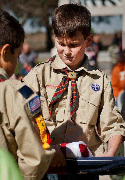 Boy Scouts from Eglin Elementary School participate in the flag folding ceremony the school’s Veterans Day ceremony at the All Wars Memorial at Eglin Air Force Base, Fla., Nov. 8. More than 400 students attended the ceremony.  (U.S. Air Force photo/Samuel King Jr.)