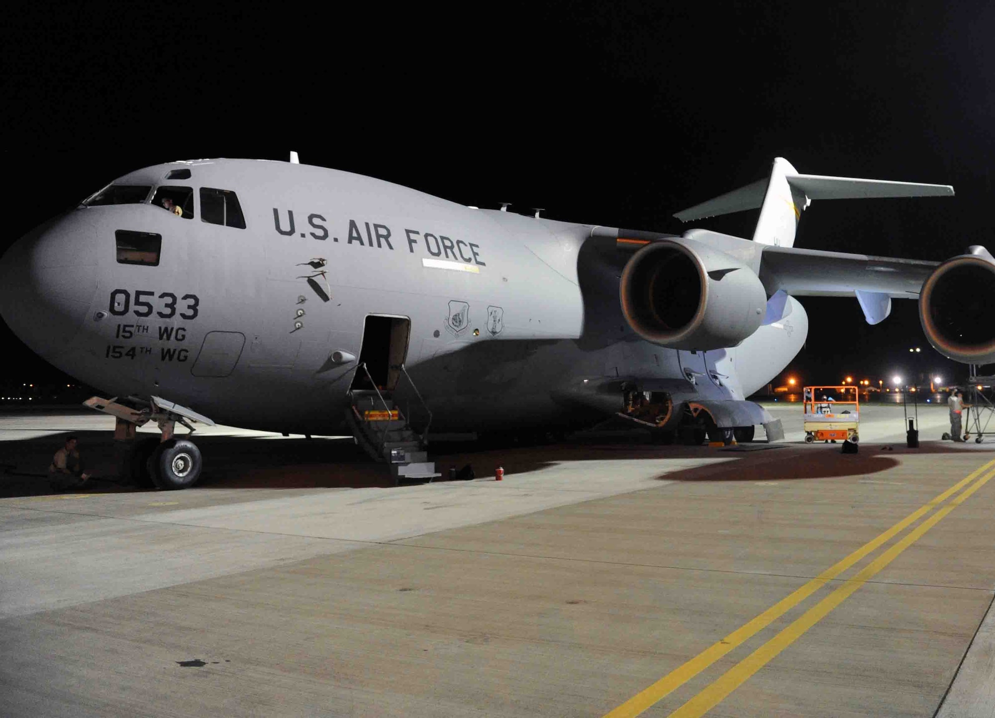 Airmen from the Hawaii Air National Guard perform maintenance on a C-17 Globemaster III Nov. 8 during an exercise at Joint Base Pearl Harbor-Hickam, Hawaii. As part of a Phase I deployment exercise, Airmen from the 154th and 15th Wings performed a "live load" on an aircraft, simulating one step in a deployment process designed to rapidly deploy Airmen in response to worldwide contingency operations. (U.S. Air Force photo by Staff Sgt. Nathan Allen)