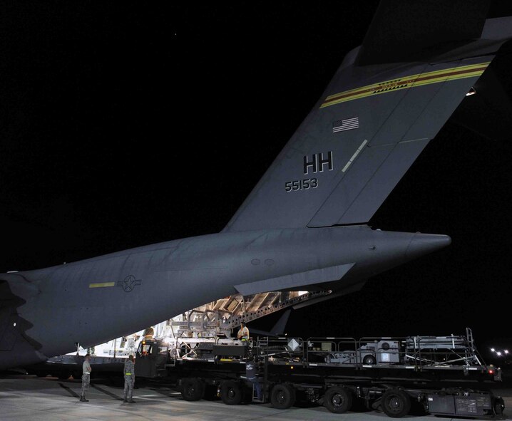 Various items are loaded onto a C-17 Globemaster III by Airmen from the 154th and 15th Wings as part of a "live load" exercise Nov. 9 at Joint Base Pearl Harbor-Hickam, Hawaii. As part of a Phase I deployment exercise, the live load  simulated one step in a deployment process designed to rapidly deploy Airmen in response to worldwide contingency operations. (U.S. Air Force photo by Staff Sgt. Nathan Allen)