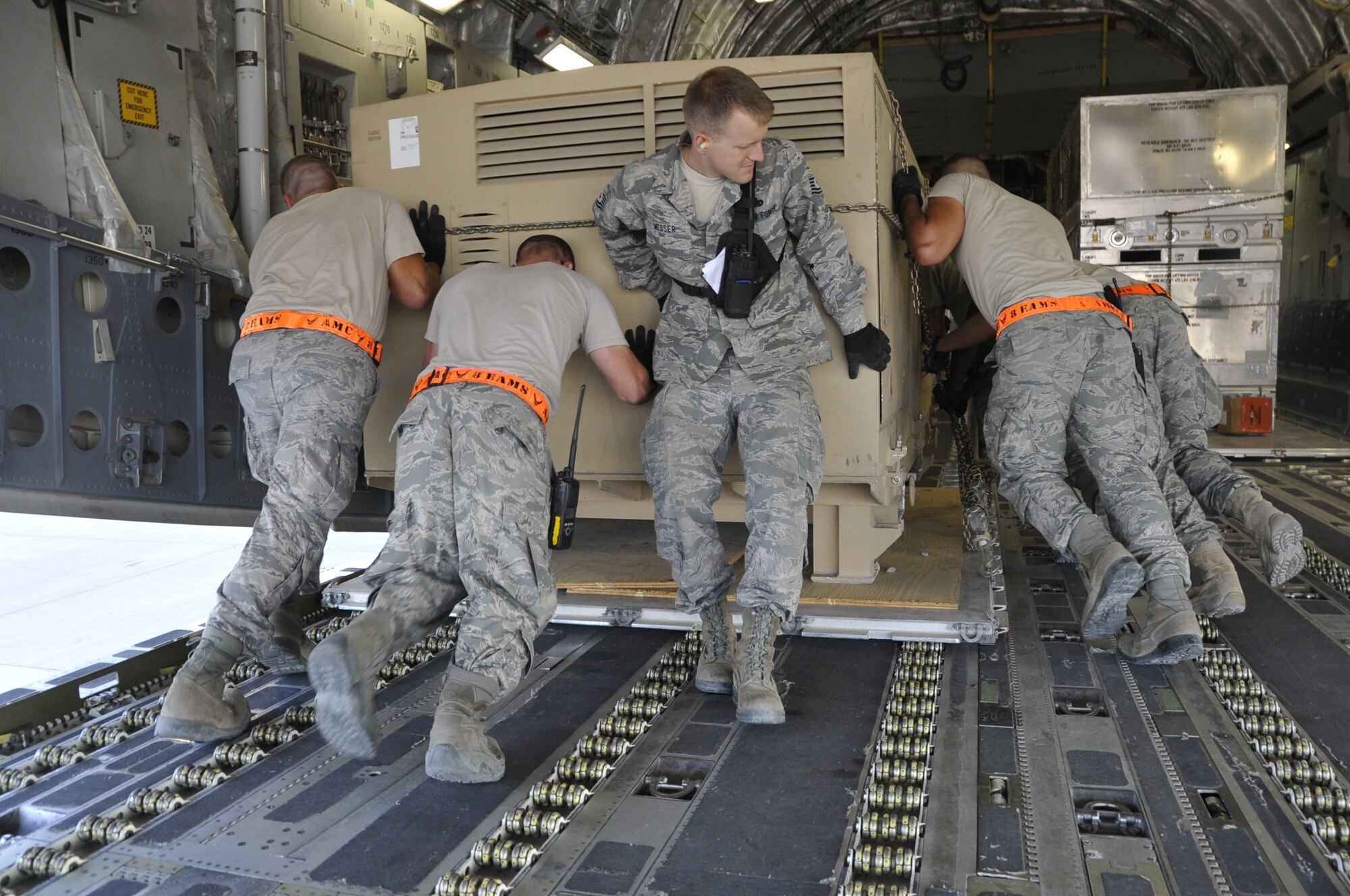 Tech. Sgt. Christopher Messer, 8th Expeditionary Air Mobility Squadron aerial port expeditor, leads the ramp services team in loading cargo onto a C-17 Globemaster III Nov. 7, 2012. Each expeditor is responsible for all ramp services and cargo movement performed by the team of dedicated Ocho’s during their 12 hour shift. Messer is deployed from the 60th Aerial Port Squadron at Travis AFB, Calif. (U.S. Air Force photo/Senior Airman Bryan Swink)