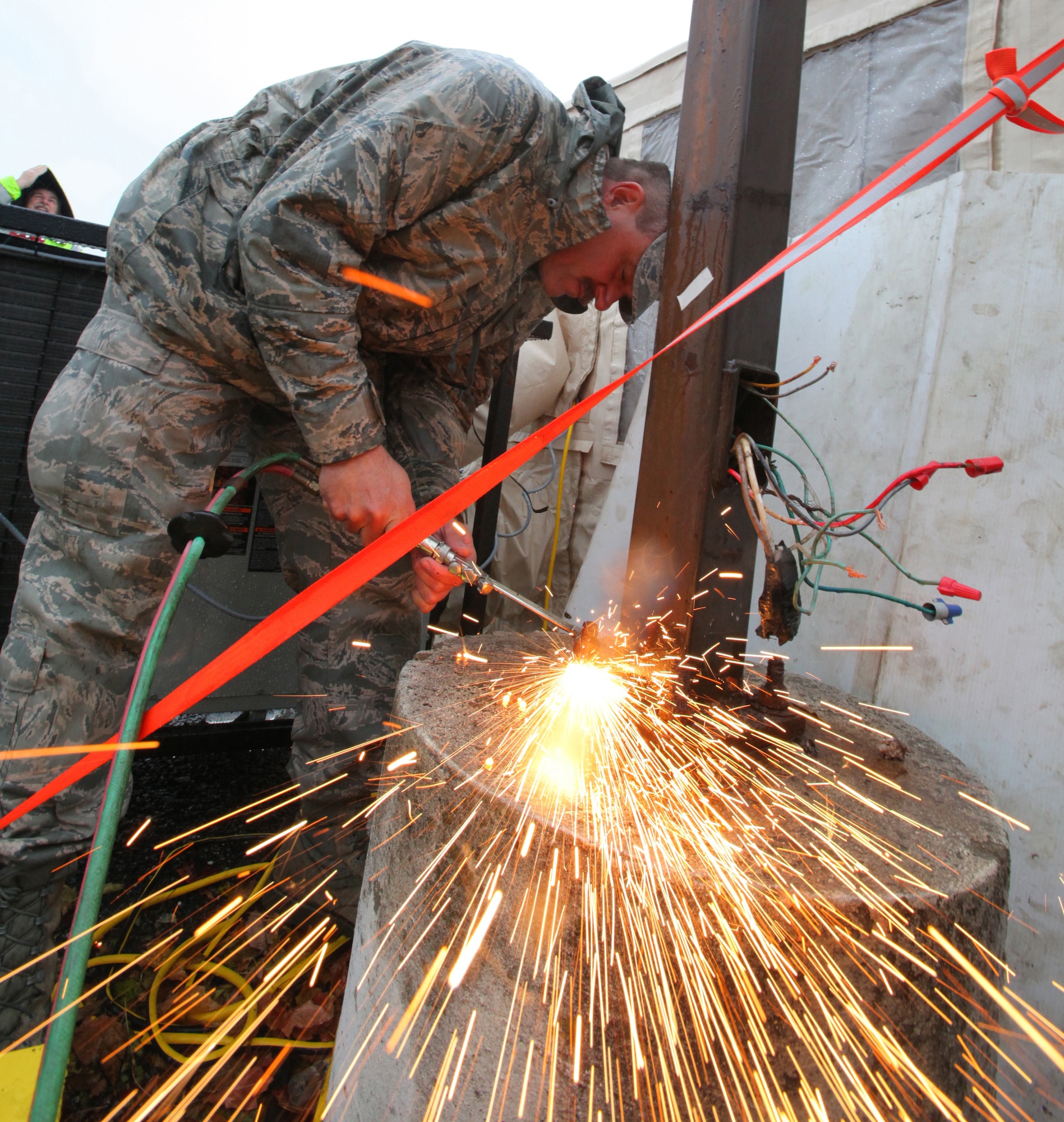 Staff Sgt. Carl Hilpl, 108th Wing, New Jersey Air National Guard, cuts the bolts holding a light pole at the Ocean County Medical Center in Brick, N.J., Nov. 7, 2012. More than 2,000 airmen and soldiers from the New Jersey National Guard have been mobilized in response to Hurricane Sandy. (U.S. Air Force photo by Master Sgt. Mark C. Olsen/Released)