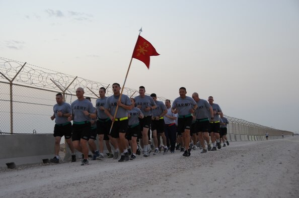 Four members from the 379th Expeditionary Civil Engineer Squadron firefighters participate in a 2.5 mile run with the Army during a “Day in the life of a Soldier,” initiative in Southwest Asia, Oct. 31, 2012. The Army program gives service members the opportunity to work side by side with the Bravo Battery, 5-52 AMD, 11th Air Defense Artillery. (U.S. Air Force photo/Staff Sgt. Sheila deVera)

