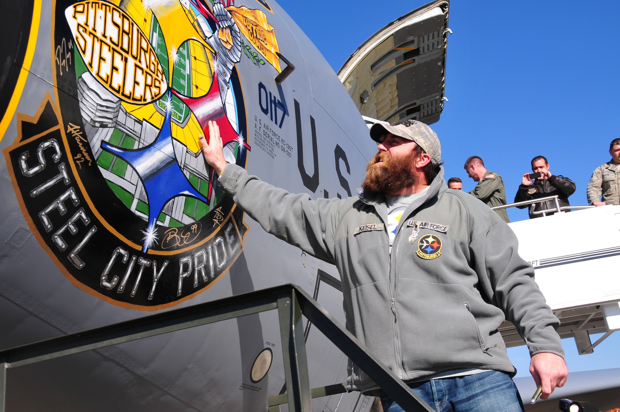 Four players from the Pittsburgh Steelers: Jonathan Dwyer, James Harrison, Brett Keisel and Doug Legursky visit the 171st Air Refueling Wing, November 6.  The visit, part of the "Salute to Service" campaign, is sponsored by the NFL in conjunction with USAA.  The NFL is also paying tribute to the Armed Forces throughout the month of November.  During the visit, the players take time to autograph one of the unit's KC-135 aircraft, Steel City Pride.
	
The Salute to Service campaign aligns with the NFL's long history of supporting America's armed services, including a partnership of more than 45 years with the USO that includes overseas visits to troops and trips to military hospitals nationwide. 

During the Pittsburgh Steelers' November 12 game, the Steelers will honor a veteran from every war, and recognize a local Harrier pilot who was shot down and killed last month over Afghanistan. The Steelers will also recognize their local military community by paying tribute to the service men and women of the 171st Air Refueling Wing. The team is partnering with USAA for a stadium-wide card stunt that features a special military appreciation message during the National Anthem. Fans will be instructed to hold up the card at their seats just before the National Anthem. 

(National Guard photo by Master Sgt. Ann Young/released)
