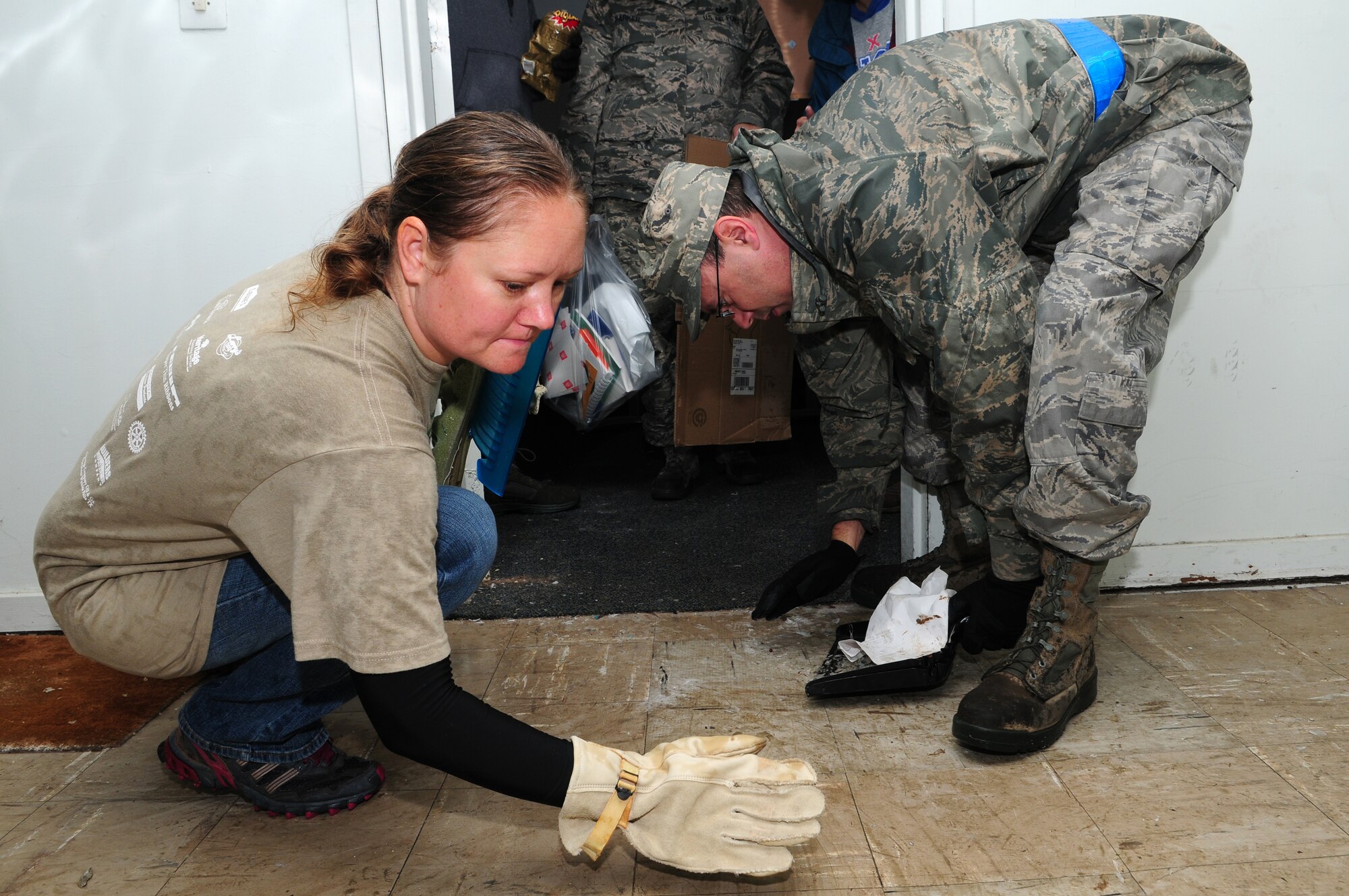 Staff Sgt. Tabitha Jones, 39th Comptroller Squadron customer service technician, and Tech. Sgt. Jody Searles, 39th Logistics Readiness Squadron mobility supervisor, pick up debris while participating in a building cleanup Nov. 9, 2012, Incirlik Air Base, Turkey. Volunteers cleaned the vacant facility, which used to be the headquarters building, to prepare it for future occupation. (U.S. Air Force photo by Tech. Sgt. Dallas Edwards/ Released) 

