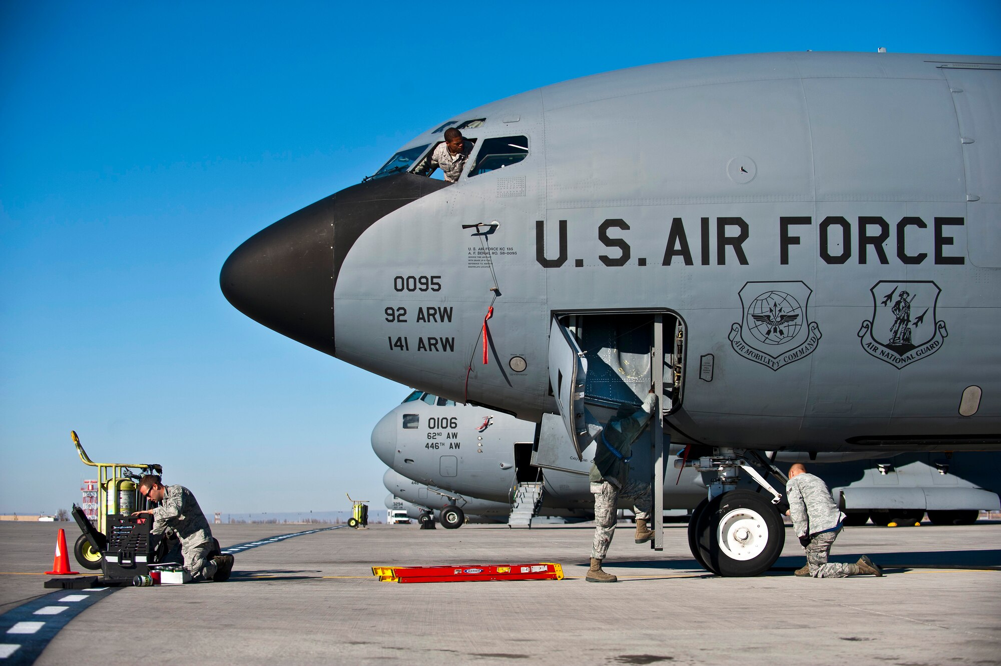 Crew chiefs from the 376th Expeditionary Aircraft Maintenance Squadron conduct maintenance on a KC-135 Stratotanker at the Transit Center at Manas, Kyrgyzstan, Nov. 8, 2012. They conduct preventative maintenance checks on every military aircraft assigned to the Transit Center after a mission. (U.S. Air Force photo/Senior Airman Brett Clashman)