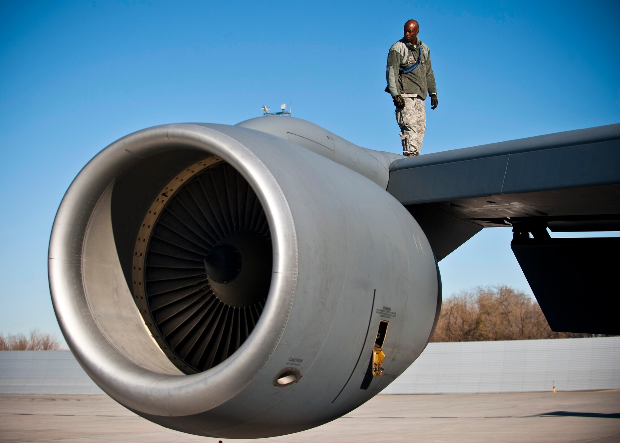 Staff Sgt. Carlos Mitchell inspects the wing of a KC-135 Stratotanker at the Transit Center at Manas, Kyrgyzstan, Nov. 8, 2012. Crew chiefs inspect the external part of the aircraft for structural damage. Mitchell is a 376th Expeditionary Aircraft Maintenance Squadron crew chief who is deployed from McConnell Air Force Base, Kan., and a native of Columbia, S.C. (U.S. Air Force photo/Senior Airman Brett Clashman)