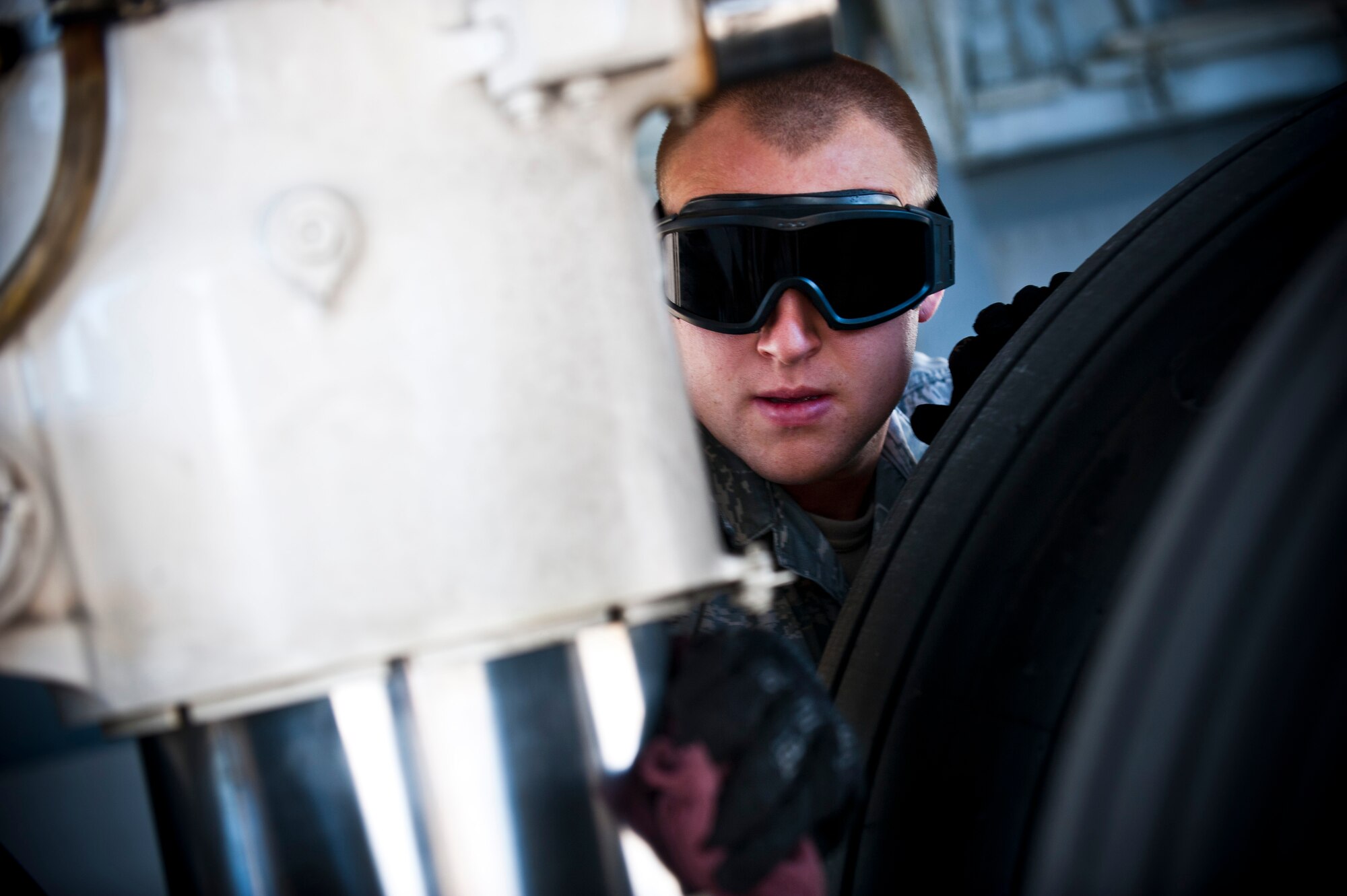 Senior Airman Cody Haynes cleans the axle of a KC-135 Stratotanker at the Transit Center at Manas, Kyrgyzstan, Nov. 8, 2012. Crew chiefs conduct preventative maintenance checks on every military aircraft assigned to the Transit Center after a mission. Haynes is a 376th Expeditionary Aircraft Maintenance Squadron crew chief who is deployed from Fairchild Air Force Base, Wash., and a native a Woodbridge, Va. (U.S. Air Force photo/Senior Airman Brett Clashman)