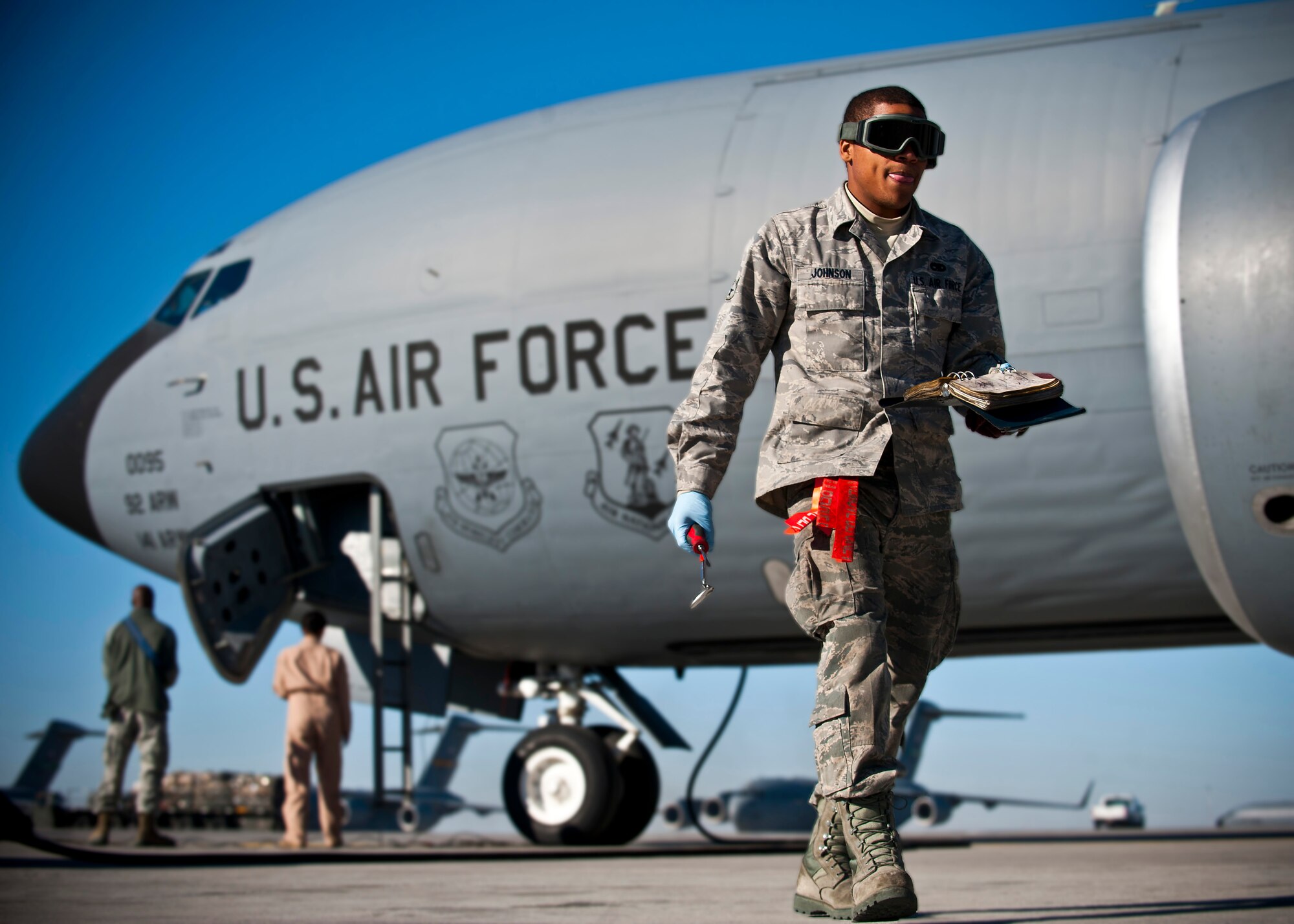 Airman 1st Class Monquavious Johnson walks to an engine of a KC-135 Stratotanker at the Transit Center at Manas, Kyrgyzstan, Nov. 8, 2012. Crew chiefs conduct preventative maintenance checks on every military aircraft assigned to the Transit Center after a mission. Johnson is a 376th Expeditionary Aircraft Maintenance Squadron crew chief who is deployed from MacDill Air Force Base, Fla., and a native of Atlanta. (U.S. Air Force photo/Senior Airman Brett Clashman)