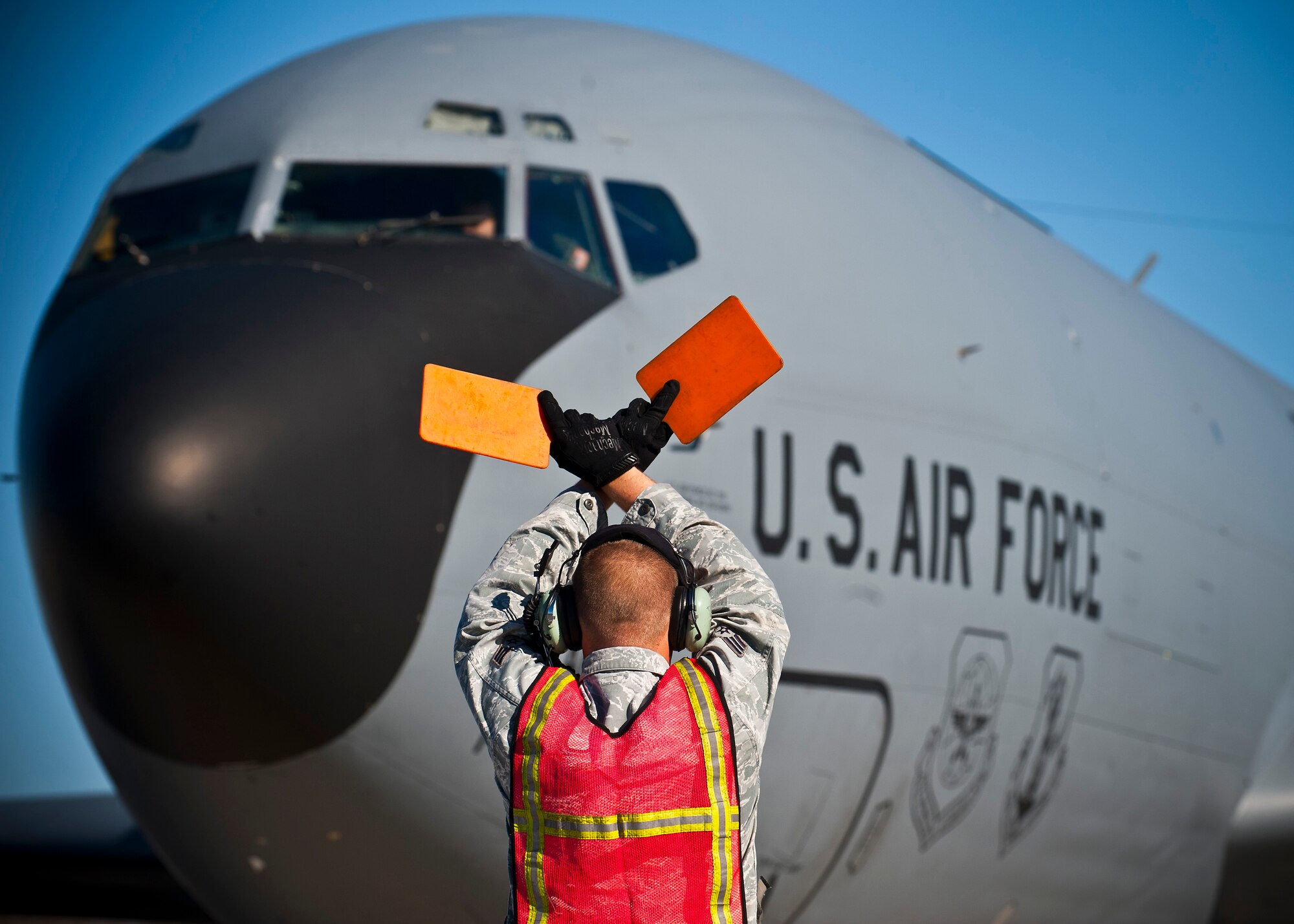 Senior Airman Cody Haynes signals a KC-135 Stratotanker at the Transit Center at Manas, Kyrgyzstan, Nov. 8, 2012. Aircraft marshaling is one-on-one visual communication between the pilot and crew chief and is a part of aircraft ground handling. Haynes is a 376th Expeditionary Aircraft Maintenance Squadron crew chief who is deployed from Fairchild Air Force Base, Wash., and is a native of Woodbridge, Va. (U.S. Air Force photo/Senior Airman Brett Clashman)