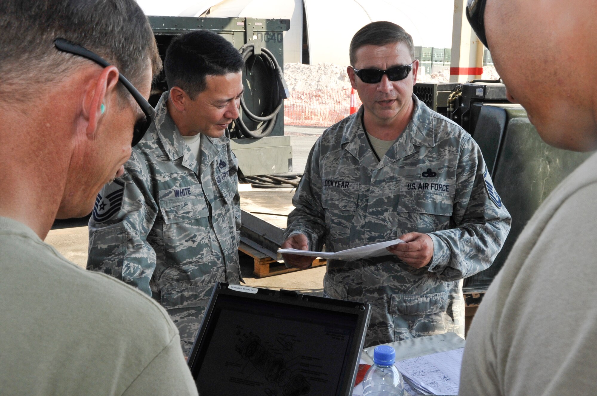 Master Sgt. Roy White (left) and Master Sgt. Terry Lockyear, 379th Expeditionary Maintenance Group Compliance Focus Team members, ensure 379th Aerospace Ground Equipment Flight maintainers have proper maintenance documentation and proper personal protective equipment Nov. 5, 2012. The 15-man Compliance Focus Team conducted more than 4,700 inspections across the 379th EMXG to evaluate the compliancy of the group's maintenance procedures and processes. (U.S. Air Force photo/Senior Airman Bryan Swink)