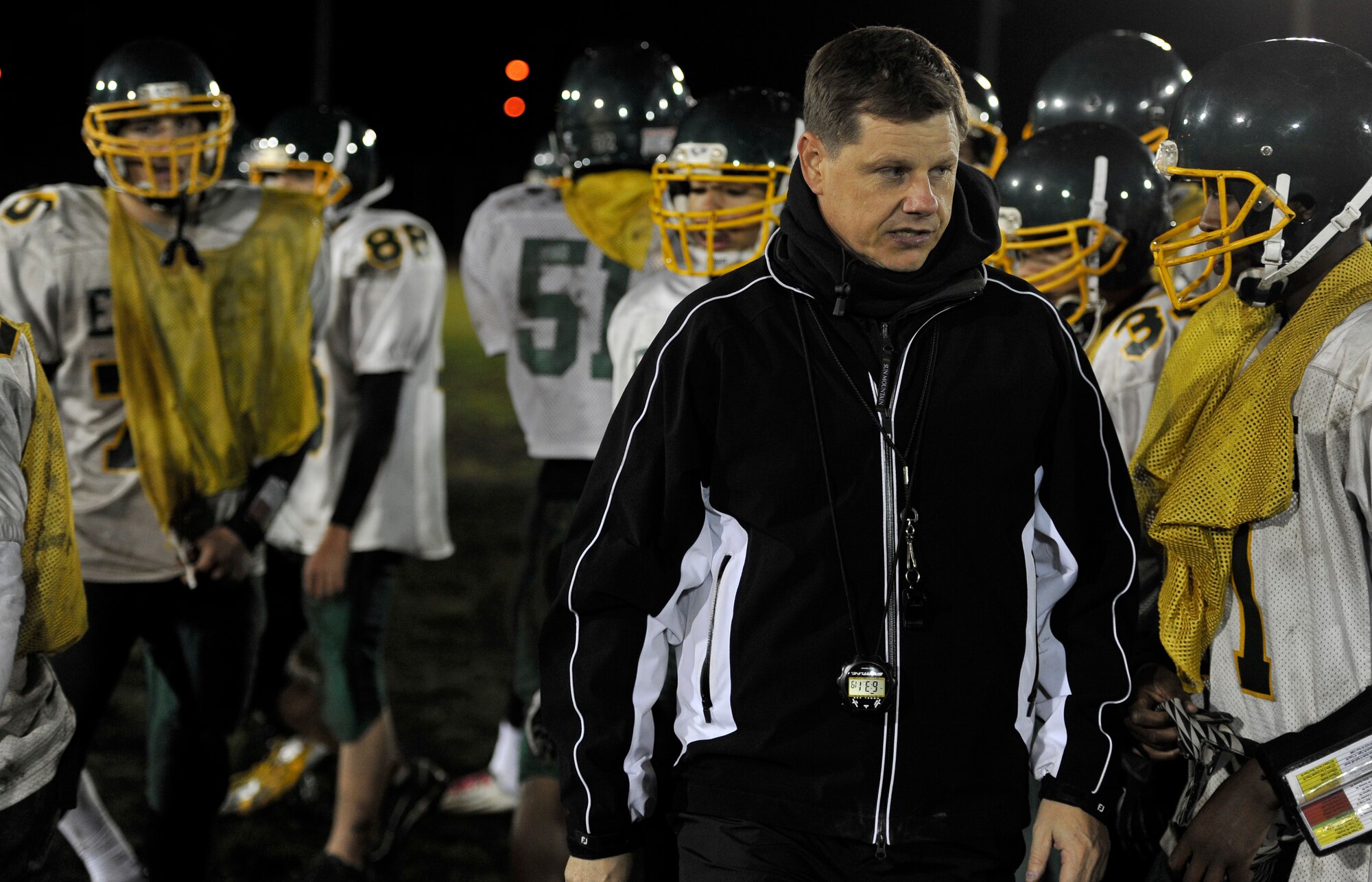 Blaine Miller, Edgren High School football head coach, leads his team off the field after practice at Misawa Air Base, Japan, Nov. 7, 2012. During practices this week, Edgren focused on the offensive play style of the Zama Trojans who they will be facing in the Division II championship game at Camp Zama, Japan, Nov. 10, 2012. (U.S. Air Force photo by Airman 1st Class Zachary Kee)