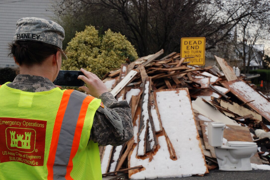 1st Lt. Erin Hanley, 554th Engineer Battalion, plots debris piles and areas of concern Nov. 8 along the coast of New Jersey as a member of the U.S. Army Corps of Engineers North Atlantic Division local government liaison team. The team sends the information back to the Division's Emergency Operations Center where personnel work with FEMA, local and state officials and agencies and military partners to begin the recovery process.