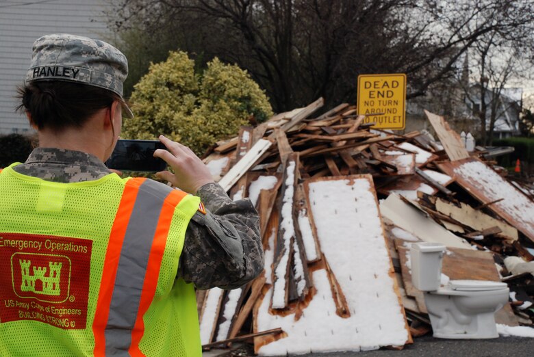 1st Lt. Erin Hanley, 554th Engineer Battalion, plots debris piles and areas of concern Nov. 8 along the coast of New Jersey as a member of the U.S. Army Corps of Engineers North Atlantic Division local government liaison team. The team sends the information back to the Division's Emergency Operations Center where personnel work with FEMA, local and state officials and agencies and military partners to begin the recovery process.