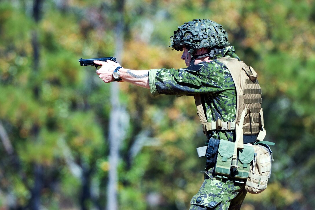 Nick Brorsen takes aim with his sidearm in the combat pistol event during the International Sniper Competition at the U.S. Army Sniper School on Fort Benning, Ga., Nov. 5, 2012. Brorsen traveled from Denmark to compete.