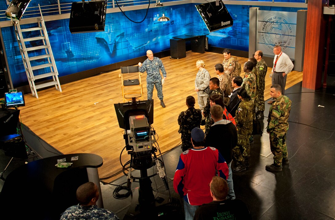 U.S. Navy Lt. Cmdr. David Luckett, center, introduces international military students to the Defense Media Activity studio for media training on Fort Meade, Md., Nov. 2, 2012. Luckett, a liaison officer, is assigned to  Defense Media Activity. The students are participants in the Defense Information School's Public Affairs Course for International Students. 

