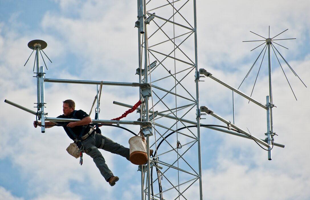 James Wolf, of LTI data communications, connects a cable to the top of the communications tower beside the 919th Special Operations Wing headquarters building at Duke Field.  Reservists will move in to the newly-renovated headquarters during the January unit training assembly.  (U.S. Air Force photo/Tech. Sgt. Samuel King Jr.)