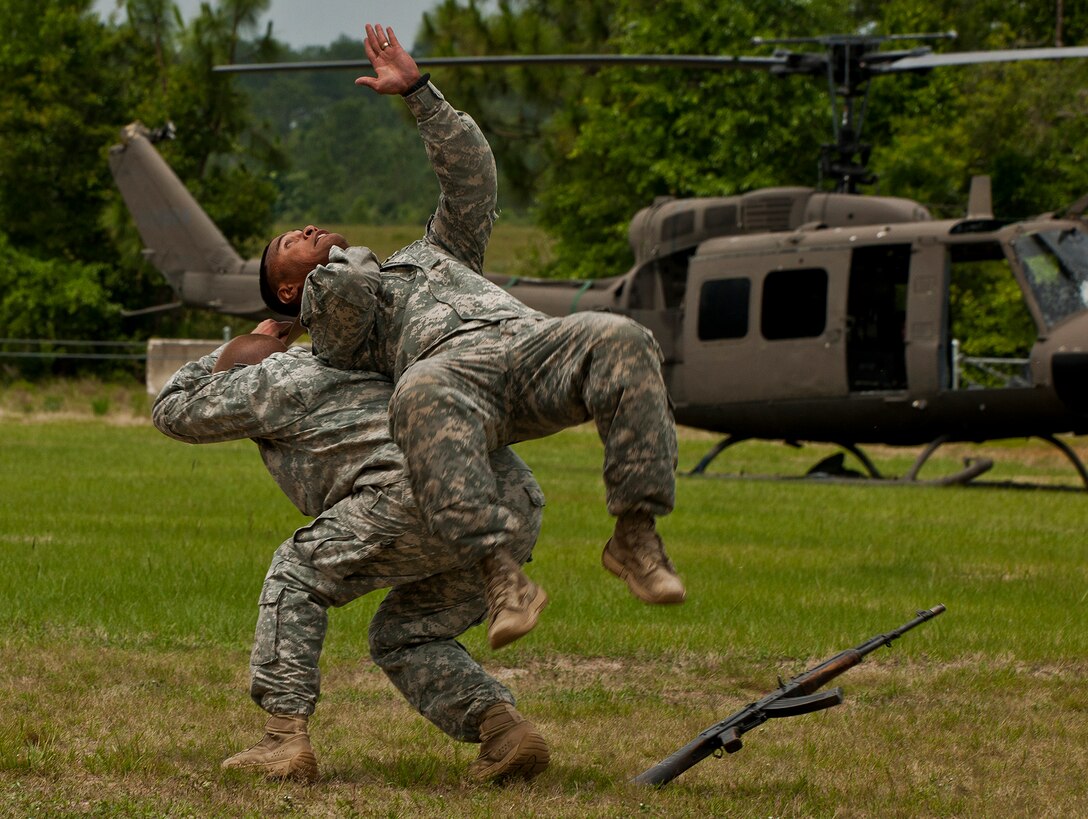 Sgt. 1st Class Chris Choay becomes the victim of a “belt takedown” performed by Sgt. 1st Class John Blayer during a hand-to-hand combat scenario at 6th Ranger Training Battalion’s Camp Rudder May 12.  Hand-to-hand combat is only a small portion of the training potential Army Rangers experience during their final phase of training.  The entire course is 61 days in length and is divided into three phases. Each phase is conducted at different geographical and environmental locations.  (U.S. Air Force photo/Tech. Sgt. Samuel King Jr.)