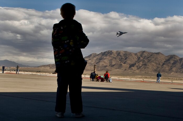 A student from the Innovations International Charter School of Nevada watches as a B-1B Lancer flies at Aviation Nation Nov. 8, 2012, at Nellis Air Force Base, Nev. Innovations International Charter School of Nevada brought more than 200 students to the Flightline Frenzy. (U.S. Air Force Photo by Senior Airman Daniel Hughes) 