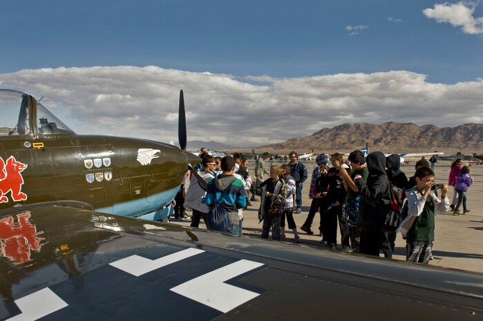 Students from the Innovations International Charter School of Nevada look at vintage aircraft on display at Aviation Nation Nov. 8, 2012, at Nellis Air Force Base, Nev. The students from the school took part in Flightline Frenzy, which allowed students from local schools get a tour of static displays at Aviation Nation 2012. (U.S. Air Force Photo by Senior Airman Daniel Hughes) 