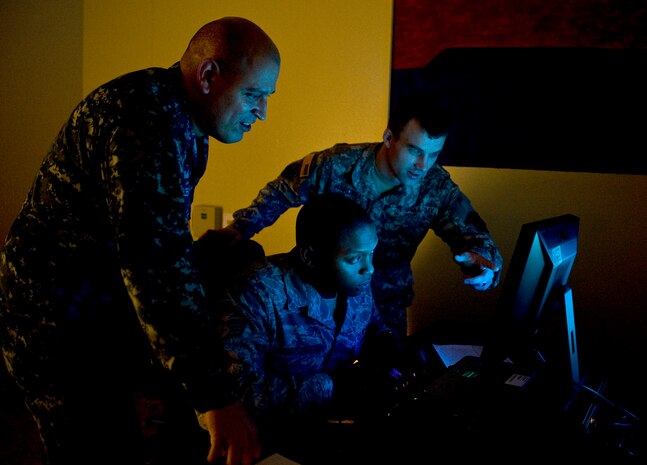 U.S. Navy Petty Officer 1st Class Joel Melendez, Naval Network Warfare Command information systems analysis, U.S. Air Force Staff Sgt. Rogerick Montgomery, U.S. Cyber Command network analysis, and U.S. Army Staff Sgt. Jacob Harding, 780th Military Intelligence Brigade cyber systems analysis, analyze an exercise scenario during Cyber Flag 13-1, Nov. 8, 2012, at Nellis Air Force Base, Nev. Cyber Flag strategically focuses on exercising the command's mission of operating and defending the Department of Defense networks across the full spectrum of operations against a realistic adversary in a virtual environment. (U.S. Air Force photo by Senior Airman Matthew Lancaster)