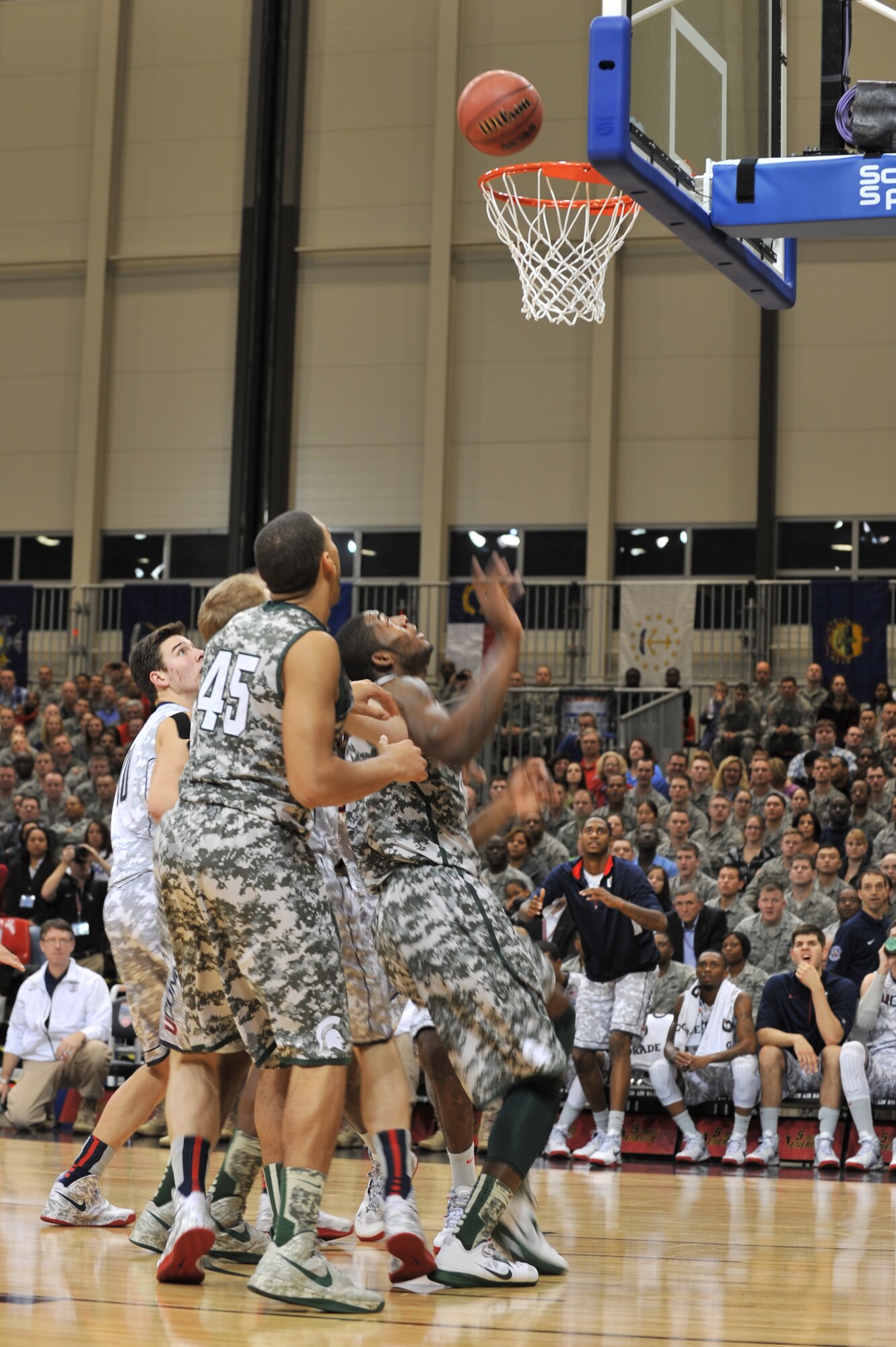 Team members from Michigan State and the University of Connecticut wait for a ball to rebound during the 2012 Armed Forces Classic on Ramstein Air Base, Germany, Nov. 10, 2012. The match-up between MSU and UCONN is part of ESPN's Veteran's week initiative to honor the men and women who have served and are still serving in the U.S. military. (U.S. Air Force photo/Senior Airman Caitlin O’Neil-McKeown)