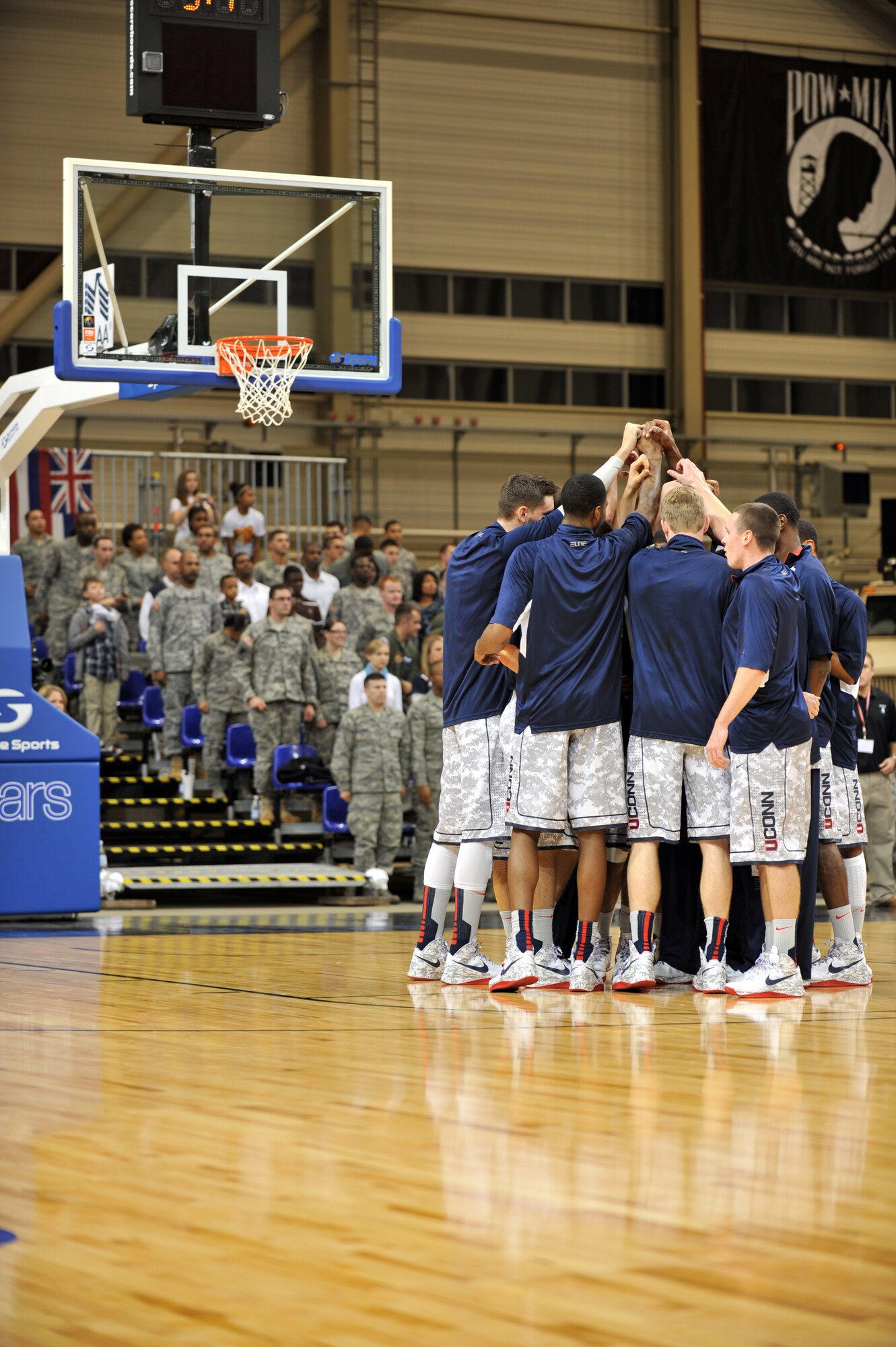 Team members from University of Connecticut have a pre game huddle at the 2012 Armed Forces Classic on Ramstein Air Base, Germany, Nov. 10, 2012. The match-up between Michigan State and UCONN is part of ESPN's Veteran's week initiative to honor the men and women who have served and are still serving in the U.S. military. (U.S. Air Force photo/Senior Airman Caitlin O’Neil-McKeown)
