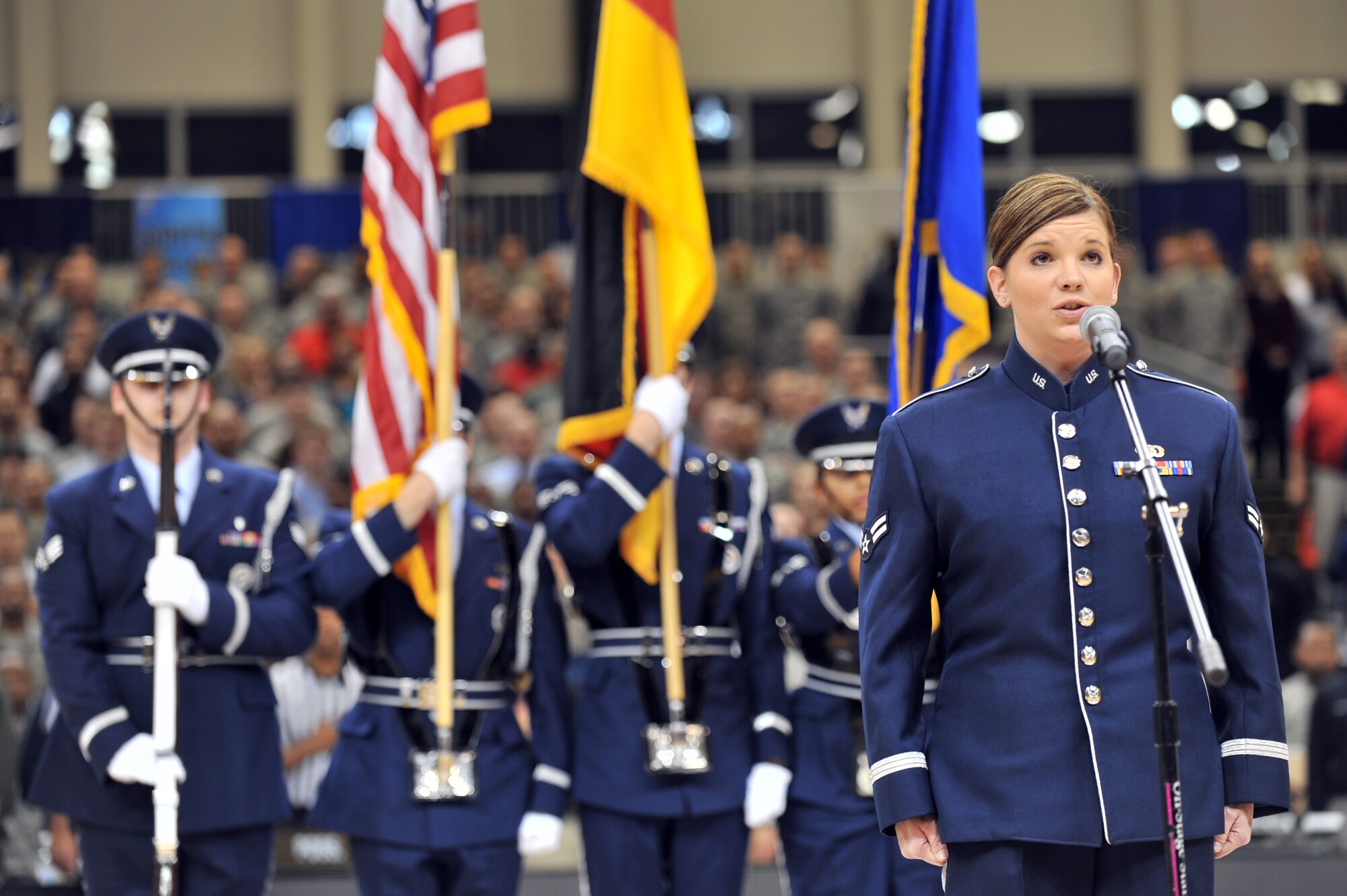 Airman 1st Class Melissa Rager, U.S. Air Forces in Europe band member, sings the German and American National Anthems at the 2012 Armed Forces Classic on Ramstein Air Base, Germany, Nov. 10, 2012. The match-up between Michigan State and University of Connecticut is part of ESPN's Veteran's week initiative to honor the men and women who have served and are still serving in the U.S. military. (U.S. Air Force photo/Senior Airman Caitlin O’Neil-McKeown)