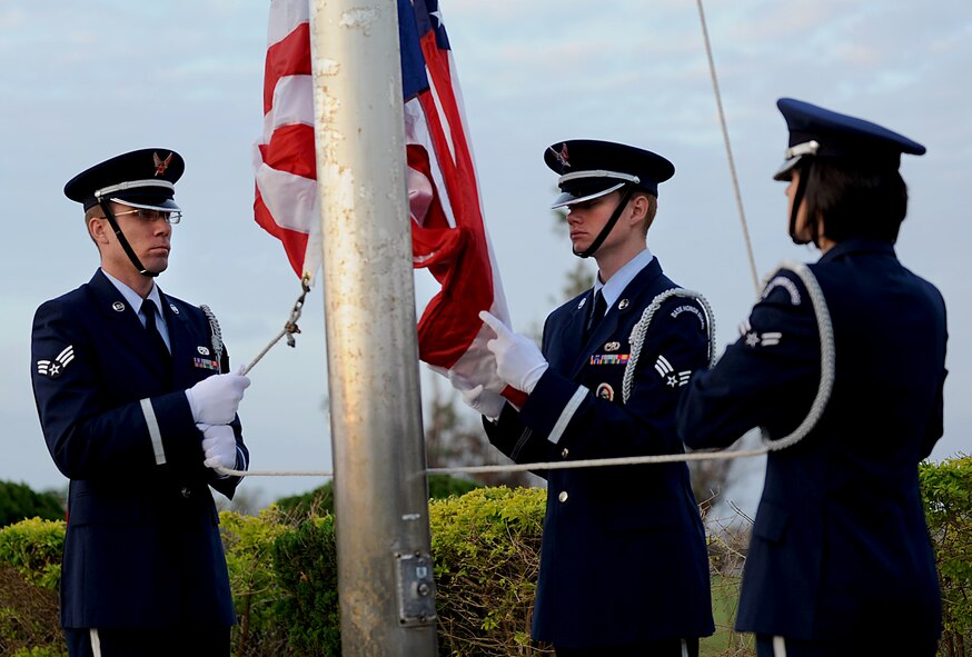 Members of the Kadena Honor guard prepare to raise the American flag as reveille sounds during the Veterans Day ceremony at the 18th Wing headquarters building on Kadena Air Base, Japan, Nov. 12, 2012. After the raising of the flag and the Japanese and American national anthems, a representative from each service recited their branch's creed and guest speakers shared their experiences with the crowd. (U.S. Air Force photo/Airman 1st Class Hailey R. Davis)