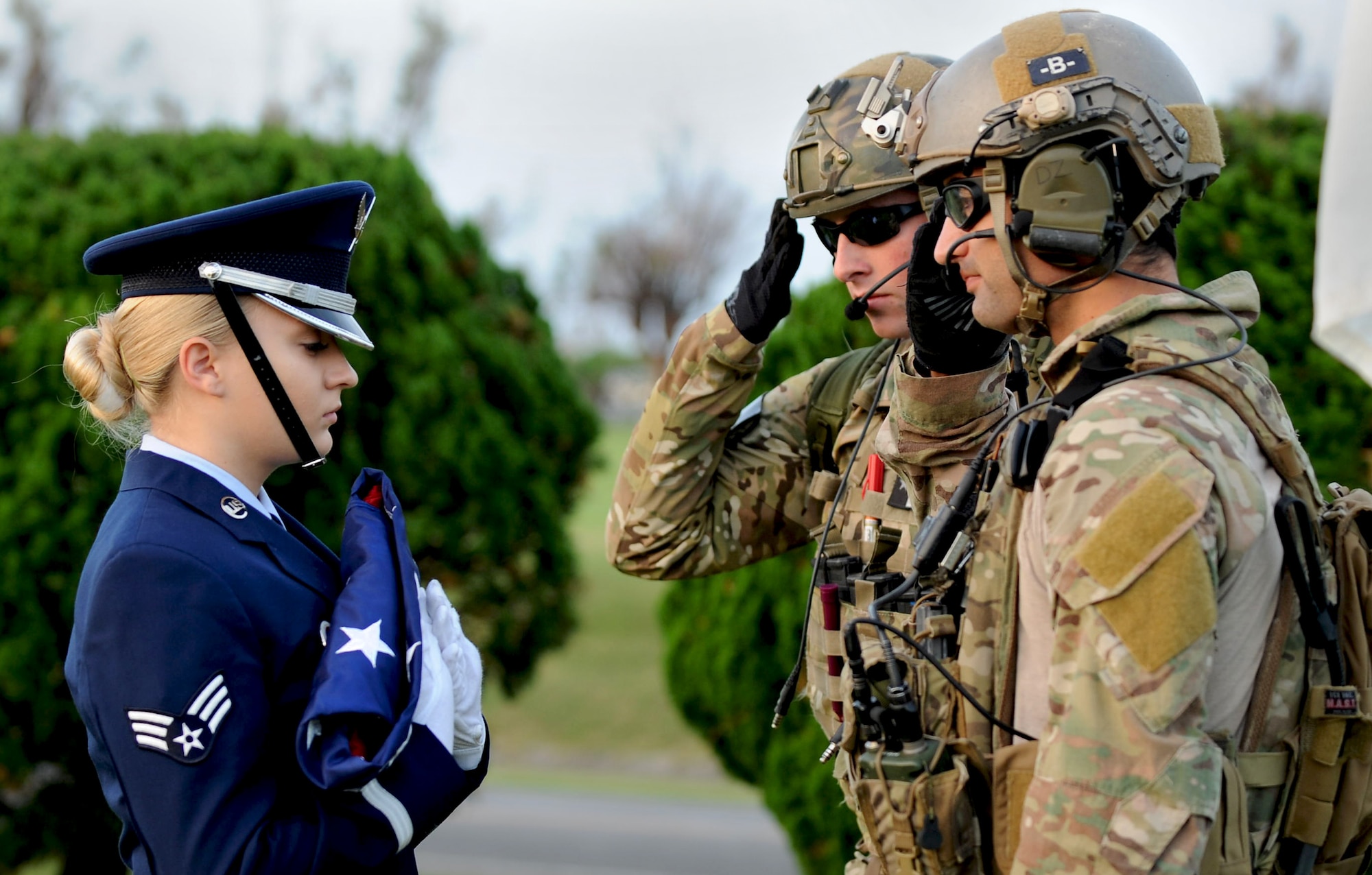 Pararescuemen from the 31st Rescue Squadron salute the American flag after handing it off to a member of the Kadena Honor Guard during the Veterans Day ceremony at the 18th Wing headquarters building on Kadena Air Base, Japan, Nov. 12, 2012. During the ceremony, members from each branch of service on Okinawa came together to recognize the sacrifices made by all U.S. veterans, past and present. (U.S. Air Force photo/Airman 1st Class Hailey R. Davis)