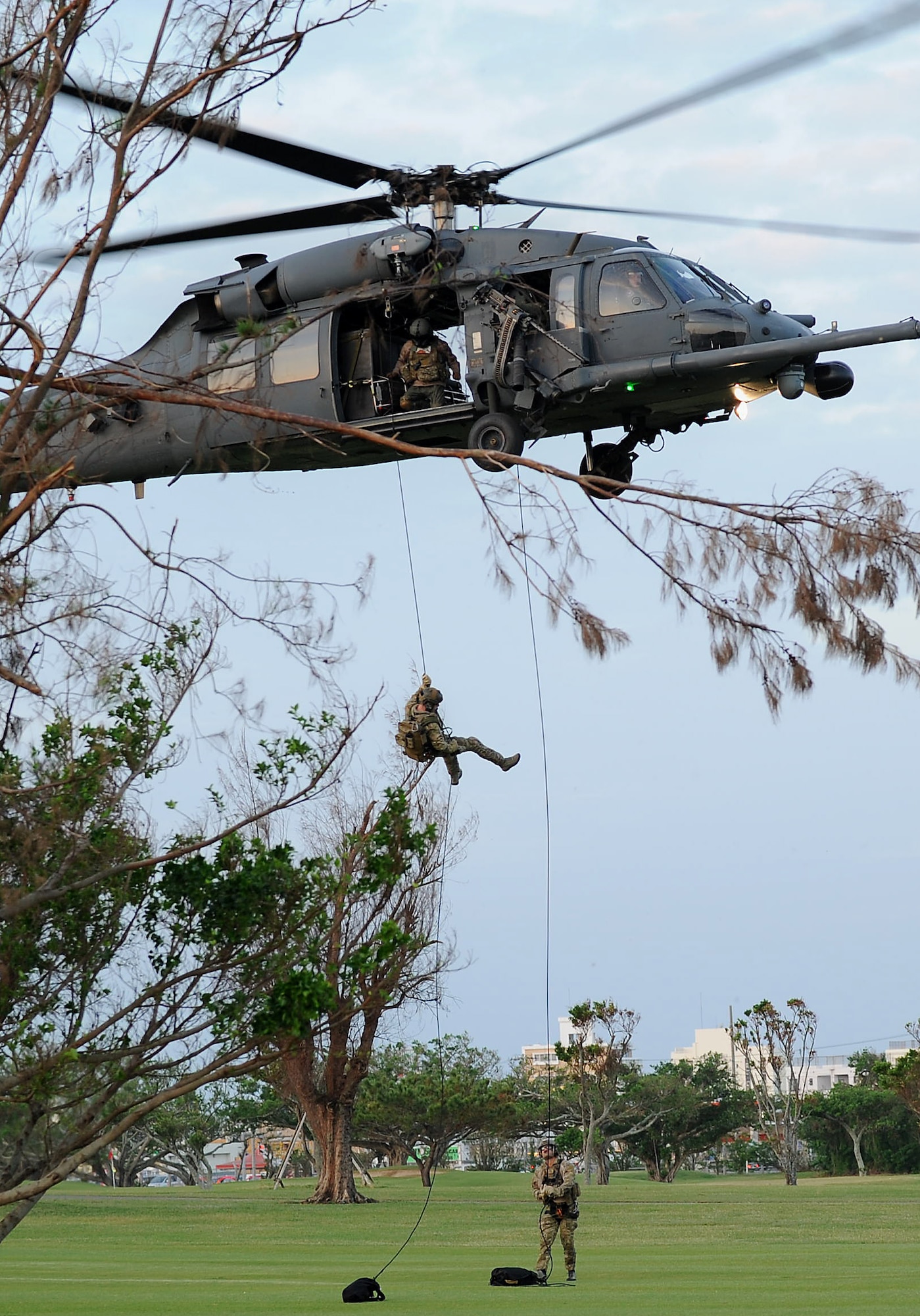 Pararescuemen from the 31st Rescue Squadron rappel from a U.S. Air Force HH-60 Pave Hawk to present the American flag during the Veterans Day ceremony at the 18th Wing headquarters building on Kadena Air Base, Japan, Nov. 12, 2012. President Woodrow Wilson first commemorated Nov. 11 as Armistice Day in 1919 to honor the veterans of World War I. The day was later changed to Veterans Day in 1954 by President Dwight Eisenhower to honor all veterans from all U.S. conflicts. (U.S. Air Force photo/Airman 1st Class Hailey R. Davis)