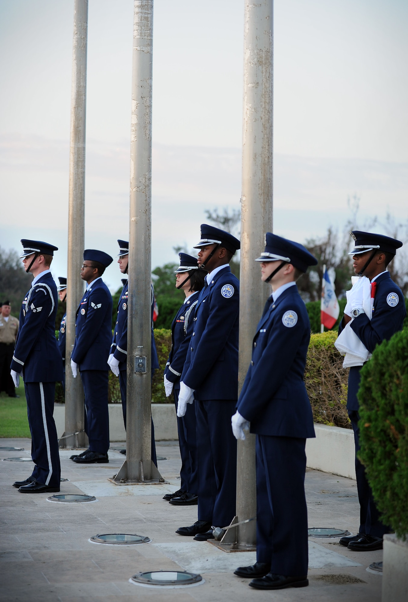 Members of the Kadena Honor Guard and Junior ROTC await the arrival of the American flag during the Veterans Day ceremony at the 18th Wing headquarters building on Kadena Air Base, Japan, Nov. 12, 2012. Veterans Day is a day dedicated to the men and women who have served and are currently serving around the world for the freedoms and liberties of all American citizens. (U.S. Air Force photo/Airman 1st Class Hailey R. Davis)