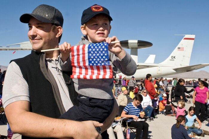 Eric Preisz and his son, Grant, watch the air demonstrations during the annual Aviation Nation open house, Nov. 11, 2012, at Nellis Air Force Base, Nev. Preisz and his family have been coming to the annual event for the past three years. (U.S. Air Force photo by Senior Airman Matthew Lancaster)