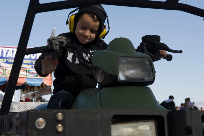Aaron Hutchinson, sits on an all terrain vehicle during the annual Aviation Nation open house Nov. 11, 2012, at Nellis Air Force Base, Nev. The all terrain vehicle display was provided by the 820th Red Horse Squadron. (U.S. Air Force photo by Airman 1st Class Christopher Tam)