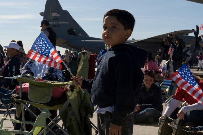 Abel Malvaez Jr. waves an American flag during the annual Aviation Nation open house Nov. 11, 2012, at Nellis Air Force Base, Nev. The Malvaez family have attended Aviation Nation every year for 6 years. (U.S. Air Force photo by Airman 1st Class Christopher Tam)