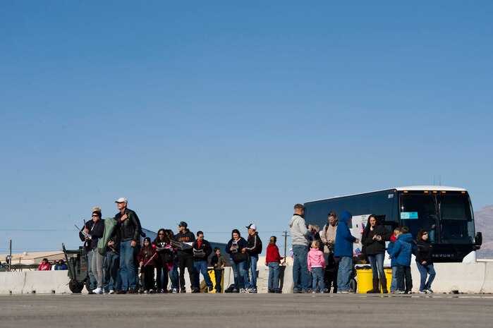 Aviation Nation spectators walk off a bus during the annual Aviation Nation open house Nov. 11, 2012, at Nellis Air Force Base, Nev. Spectators of Aviation Nation that are not in the military are transported to Nellis by bus from the Las Vegas Motor Speedway. (U.S. Air Force photo by Airman 1st Class Christopher Tam)  