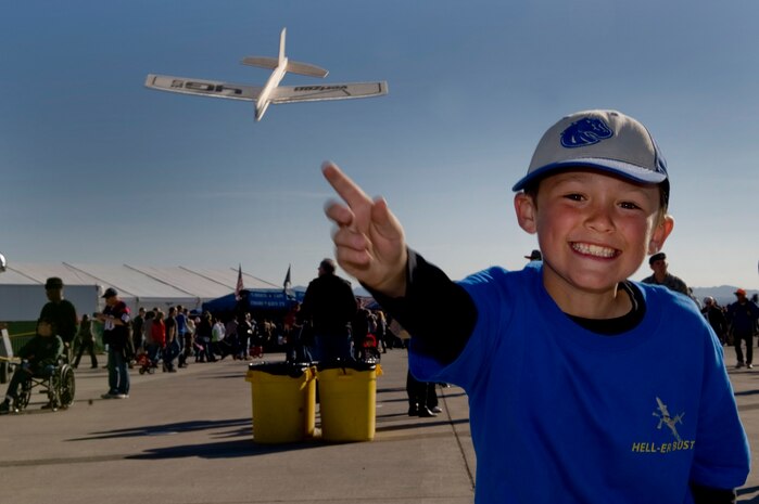 Samuel Edwards plays with a balsa wood glider during Aviation Nation Nov.11, 2012, at Nellis Air Force Base, Nev. Food, beverages and novelties were available for purchase at several locations within the event venue. (U.S. Air Force photo by Staff Sgt. William P. Coleman)
  