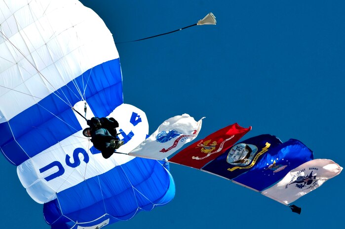 A Cadet from the United States Air Force Academy Wings of Blue demonstration team carries the flags of the U.S. military branches during Aviation Nation 2012 Nov. 11, 2012, at Nellis Air Force Base, Nev. The Wings of Blue makes roughly 19,000 training jumps annually, resulting in approximately 700 Airmen earning their jump wings. (U.S. Air Force Photo By Senior Airman Daniel Hughes)